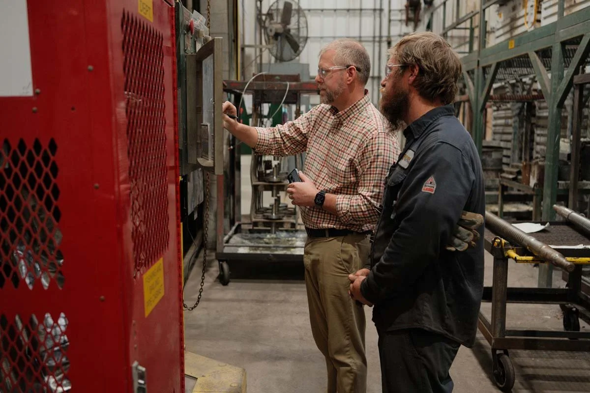 Centurion Metalworks team members reviewing manufacturing equipment