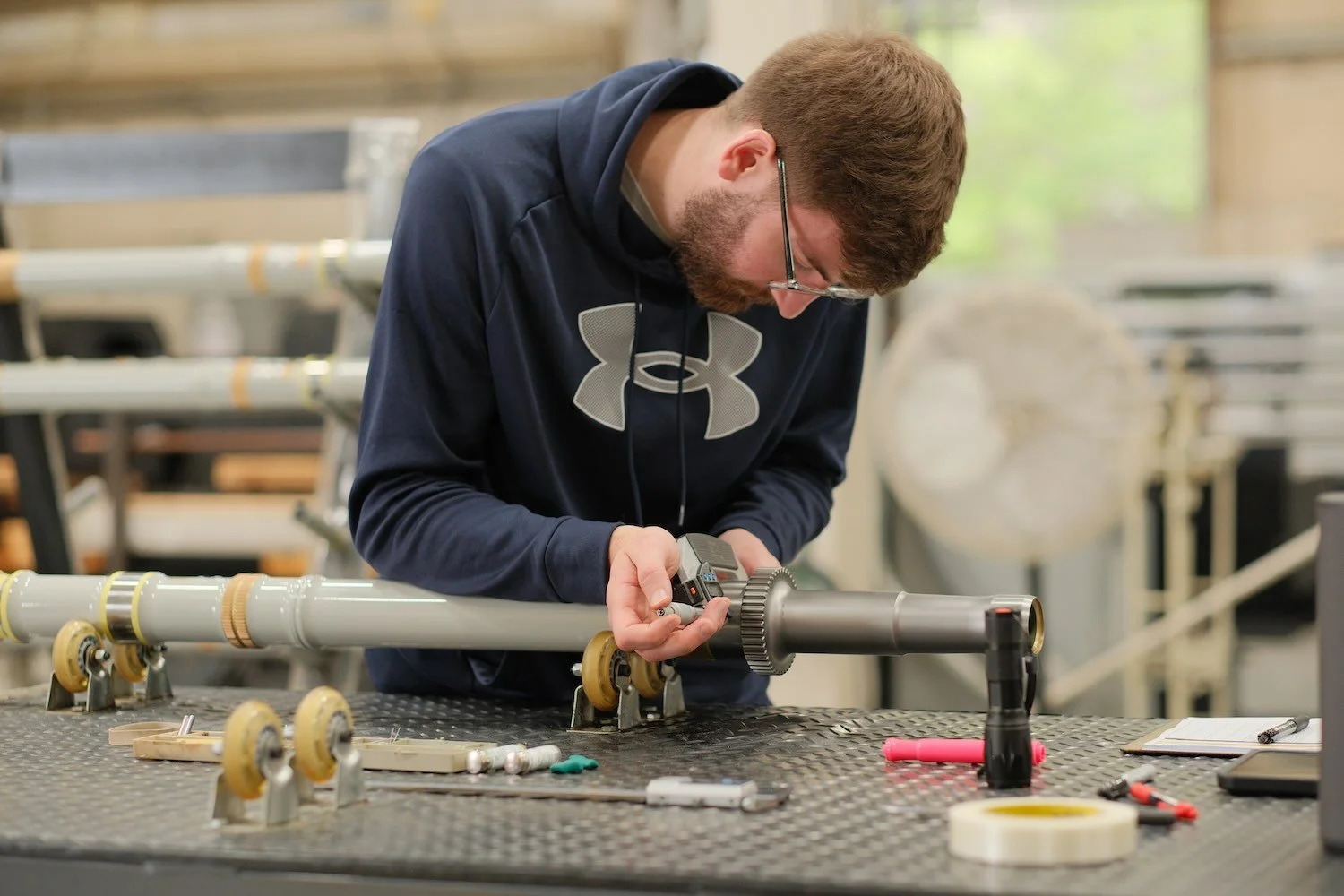 Centurion Metalworks employee inspecting a manufactured component