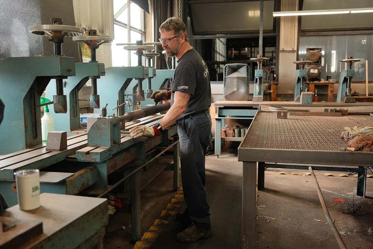 Machinist working at a production station at Centurion Metalworks