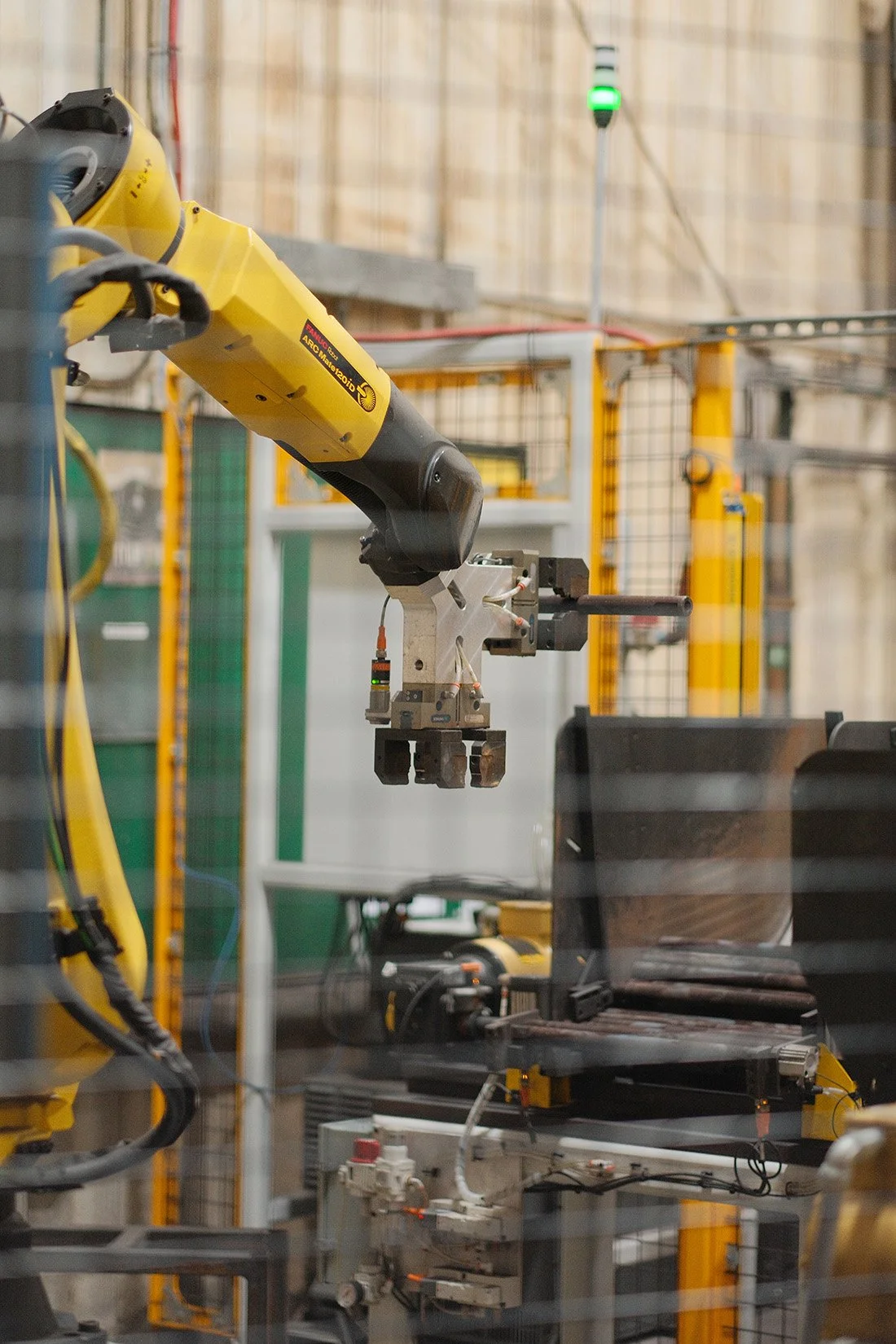 Robotic arm operating inside a Centurion Metalworks manufacturing facility