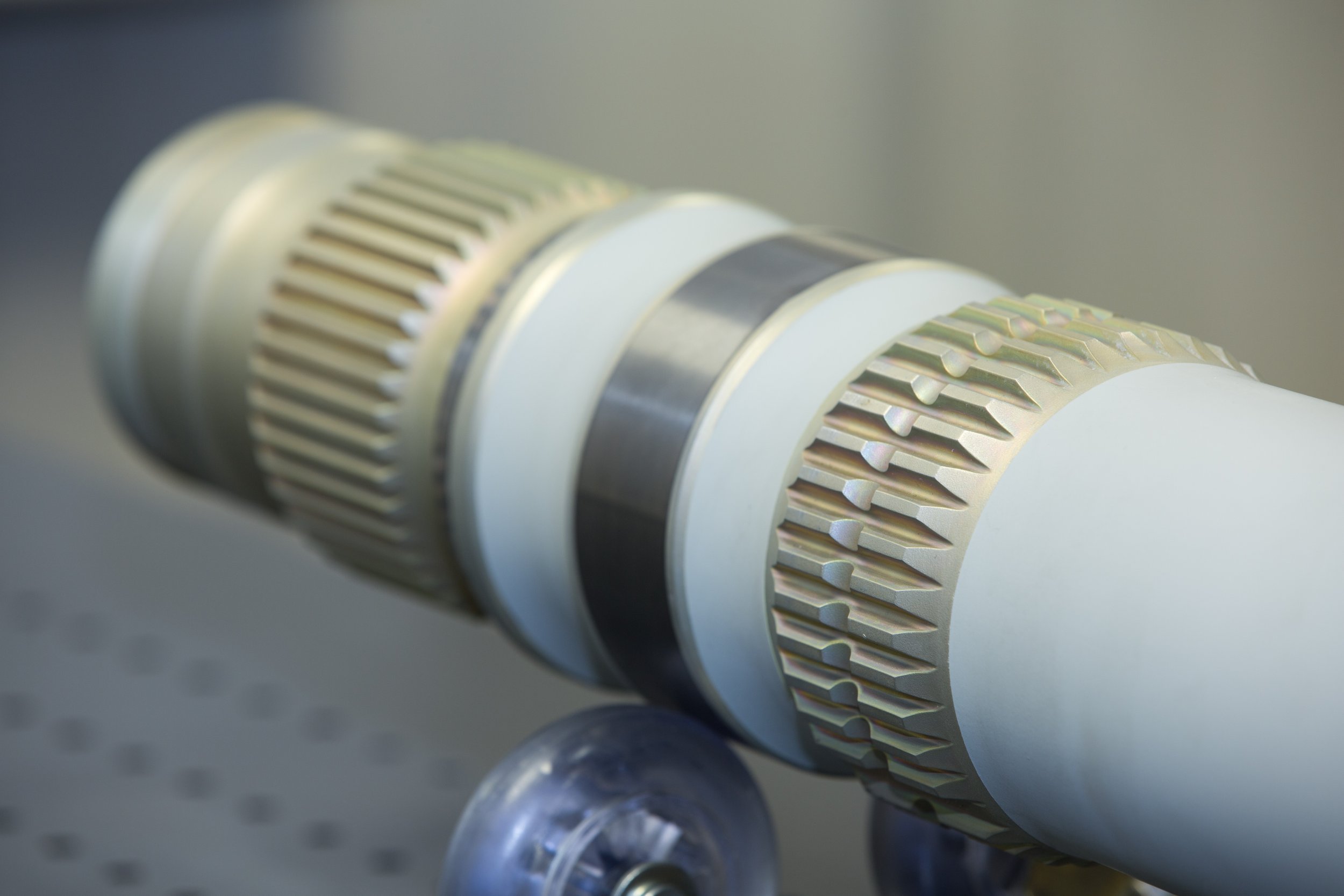 Precision-machined cylindrical component with detailed gear features