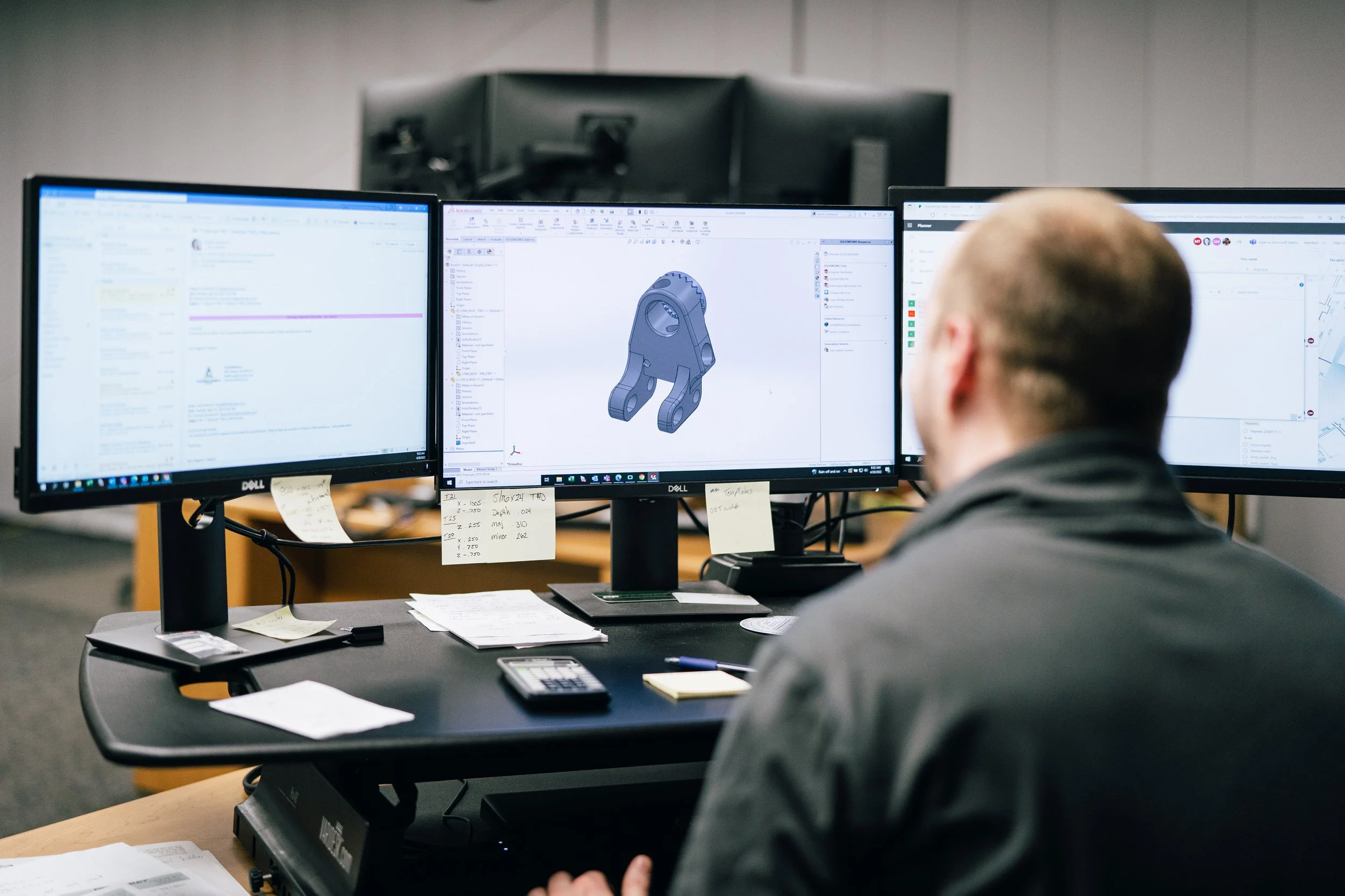 Engineer reviewing a 3D part model for design for manufacturing