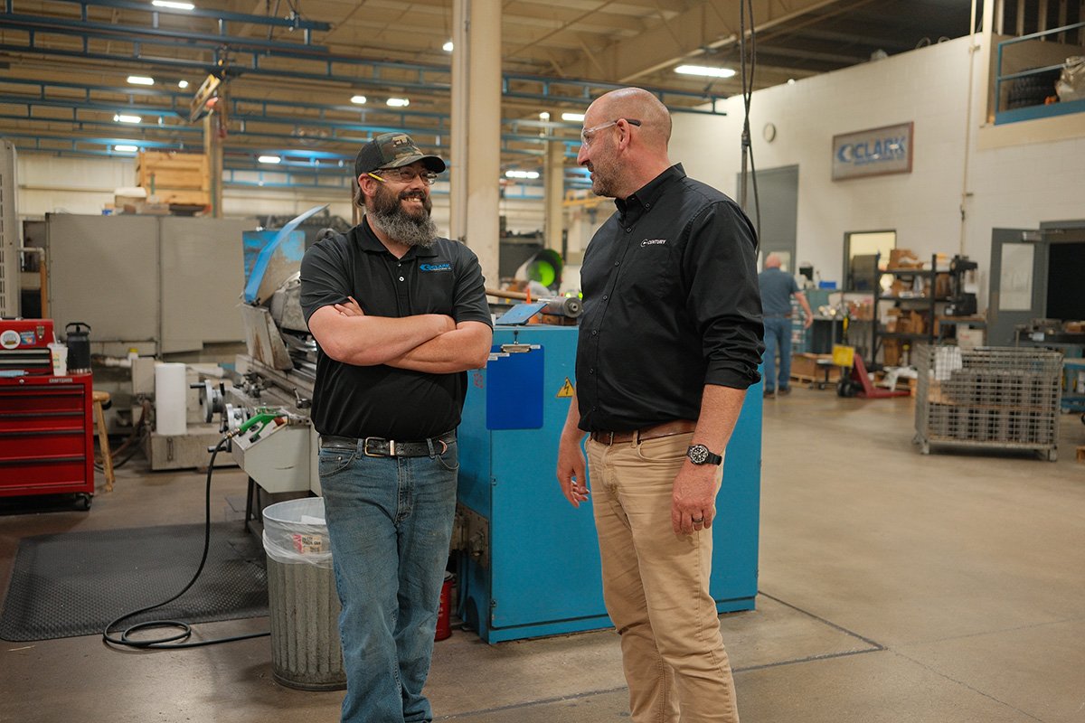Centurion Metalworks team members talking on the manufacturing floor