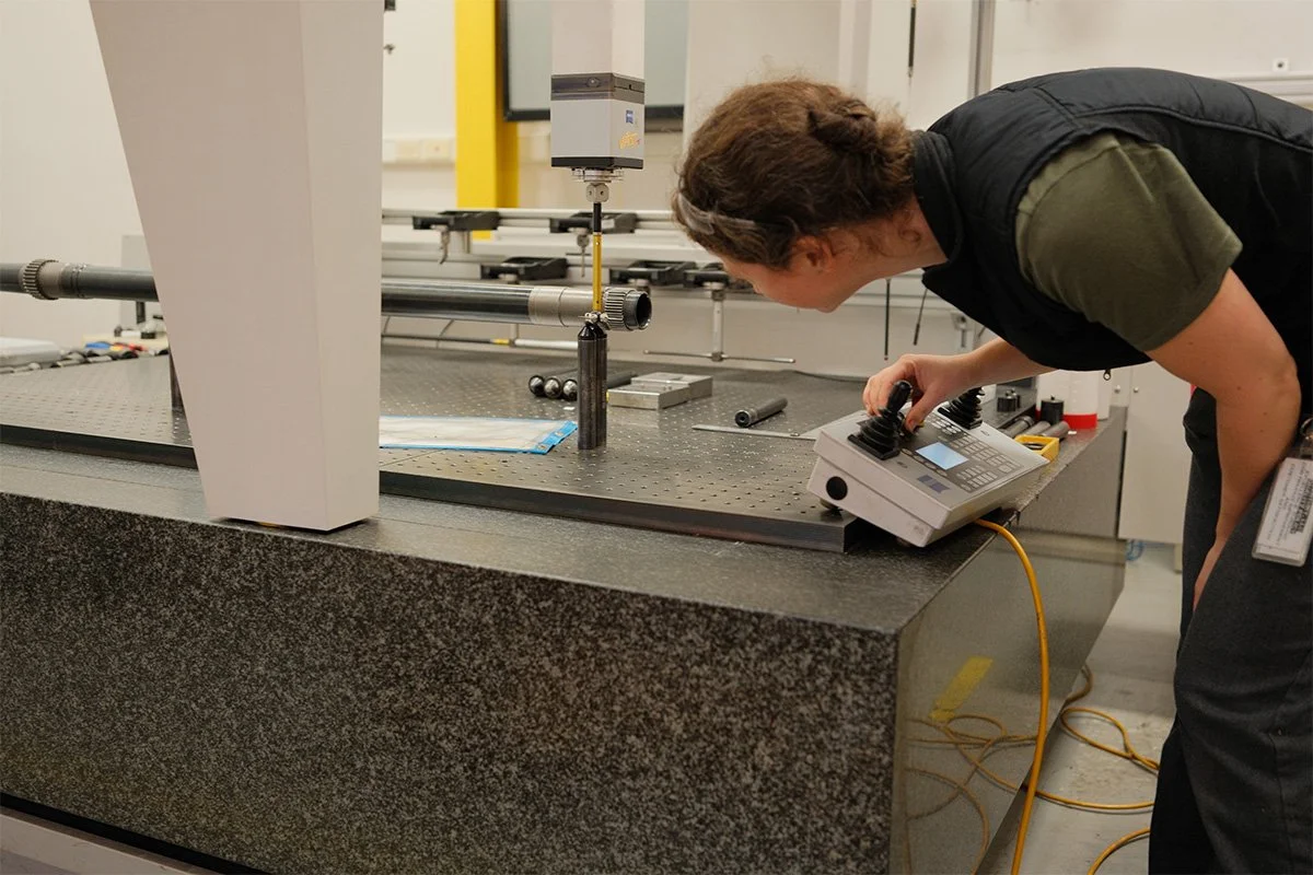 Quality technician inspecting a precision component at Centurion Metalworks