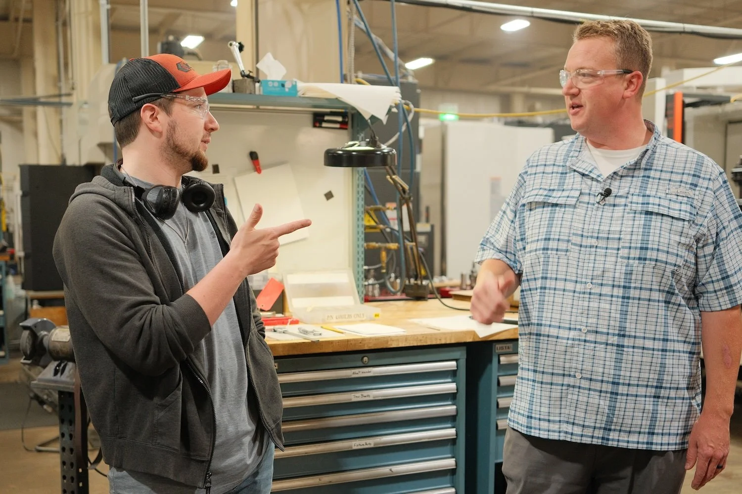 Centurion Metalworks team members discussing a manufacturing program on the shop floor