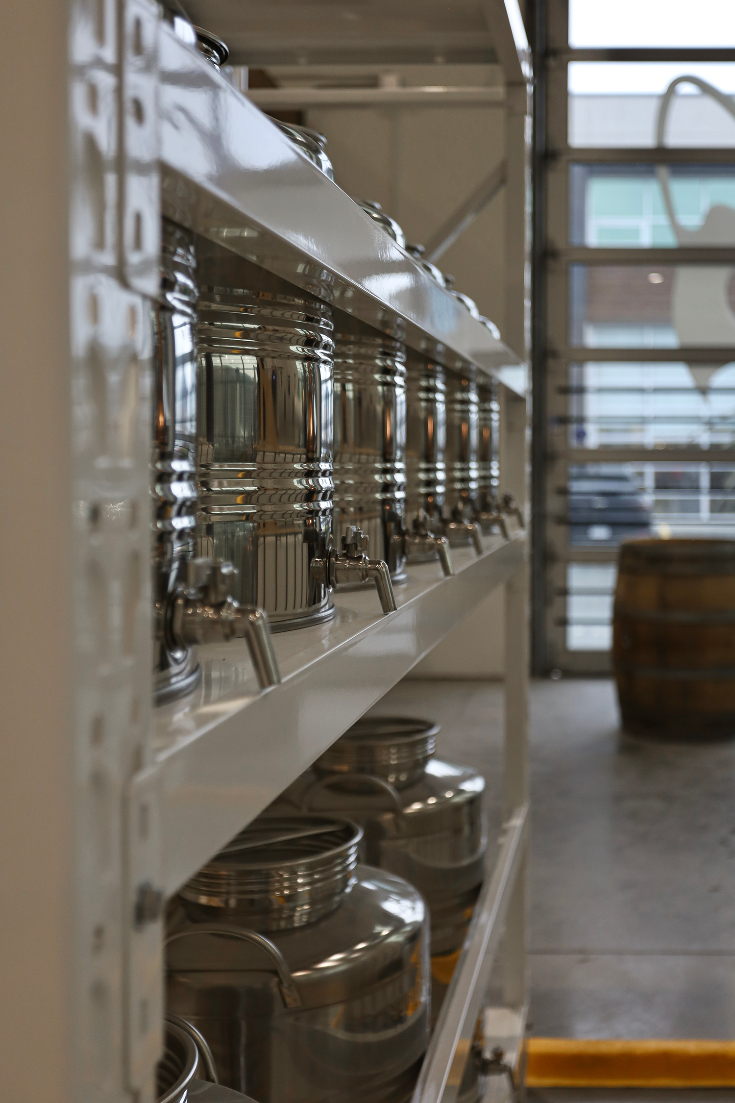 A row of metal buffet chafing dishes with lids on a white counter at a restaurant or buffet.
