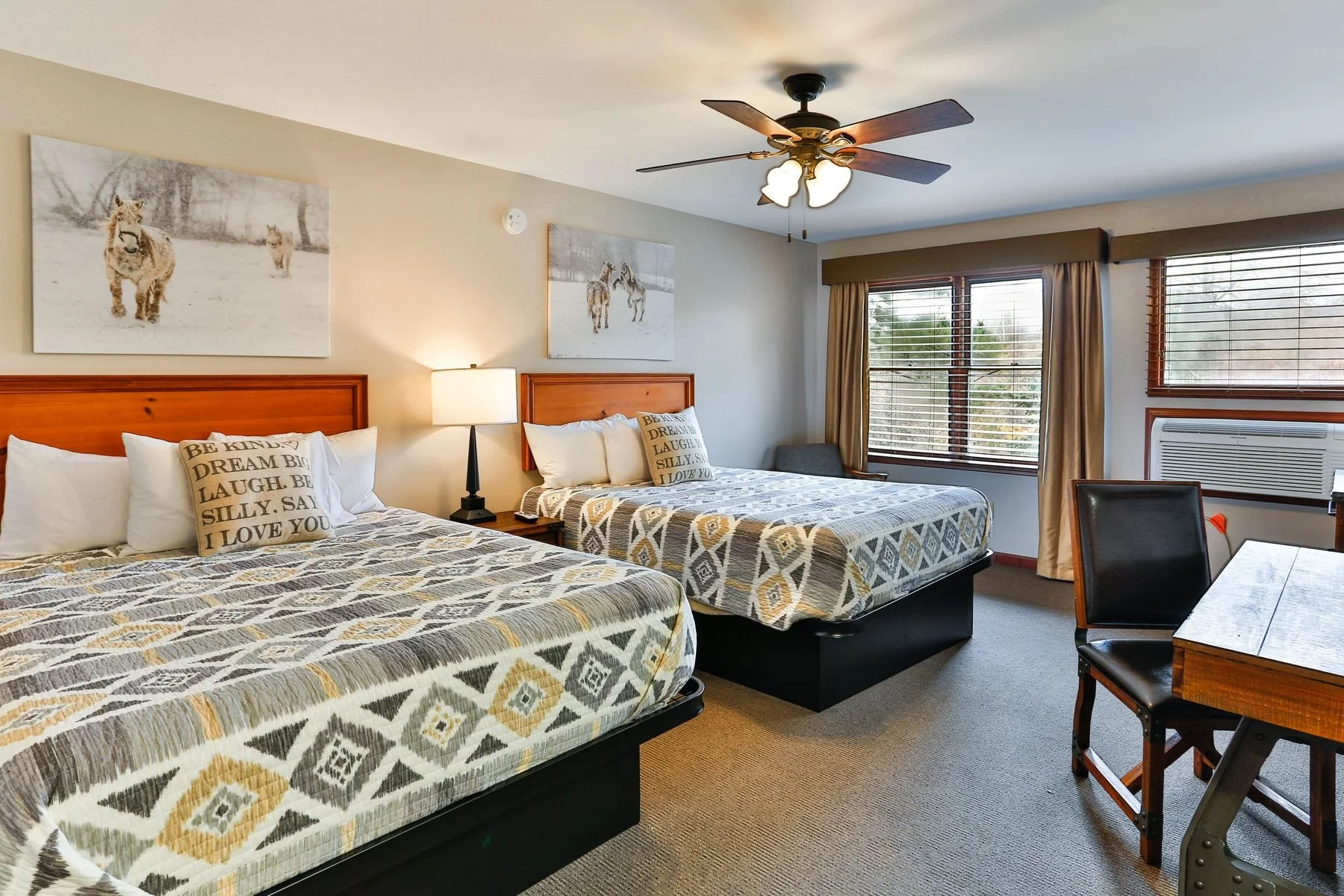 Cozy lodge-style hotel room featuring two queen beds at Forrest Hills Resort.