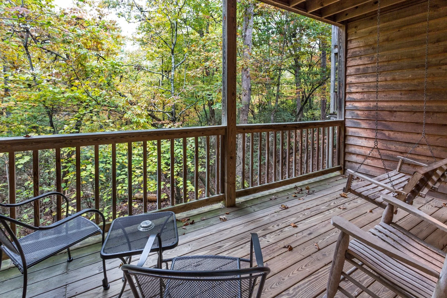 Scenic balcony view overlooking the 140-acre wooded resort property outside a two-story bi-level King Suite.
