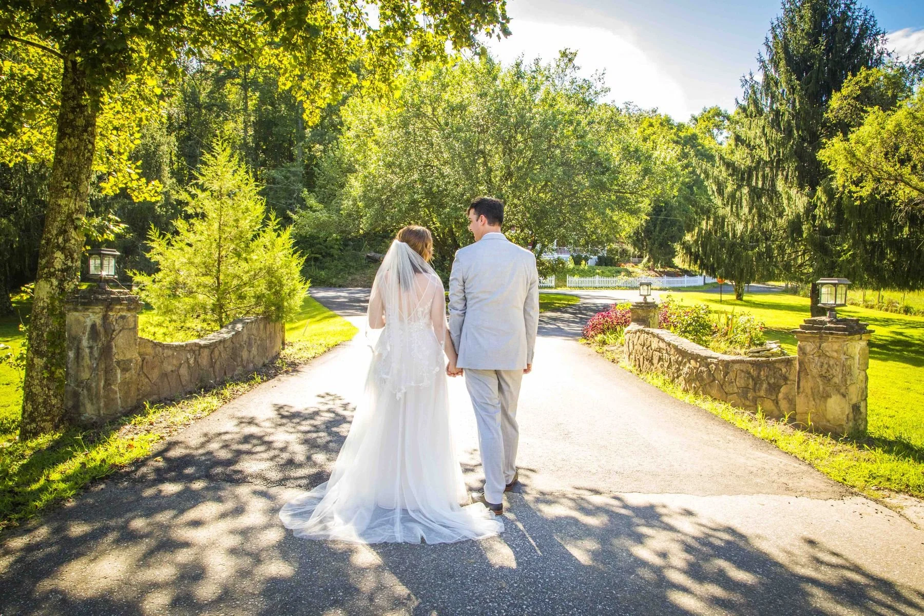 Wedding couple walking across a bridge at Forrest Hills Resort