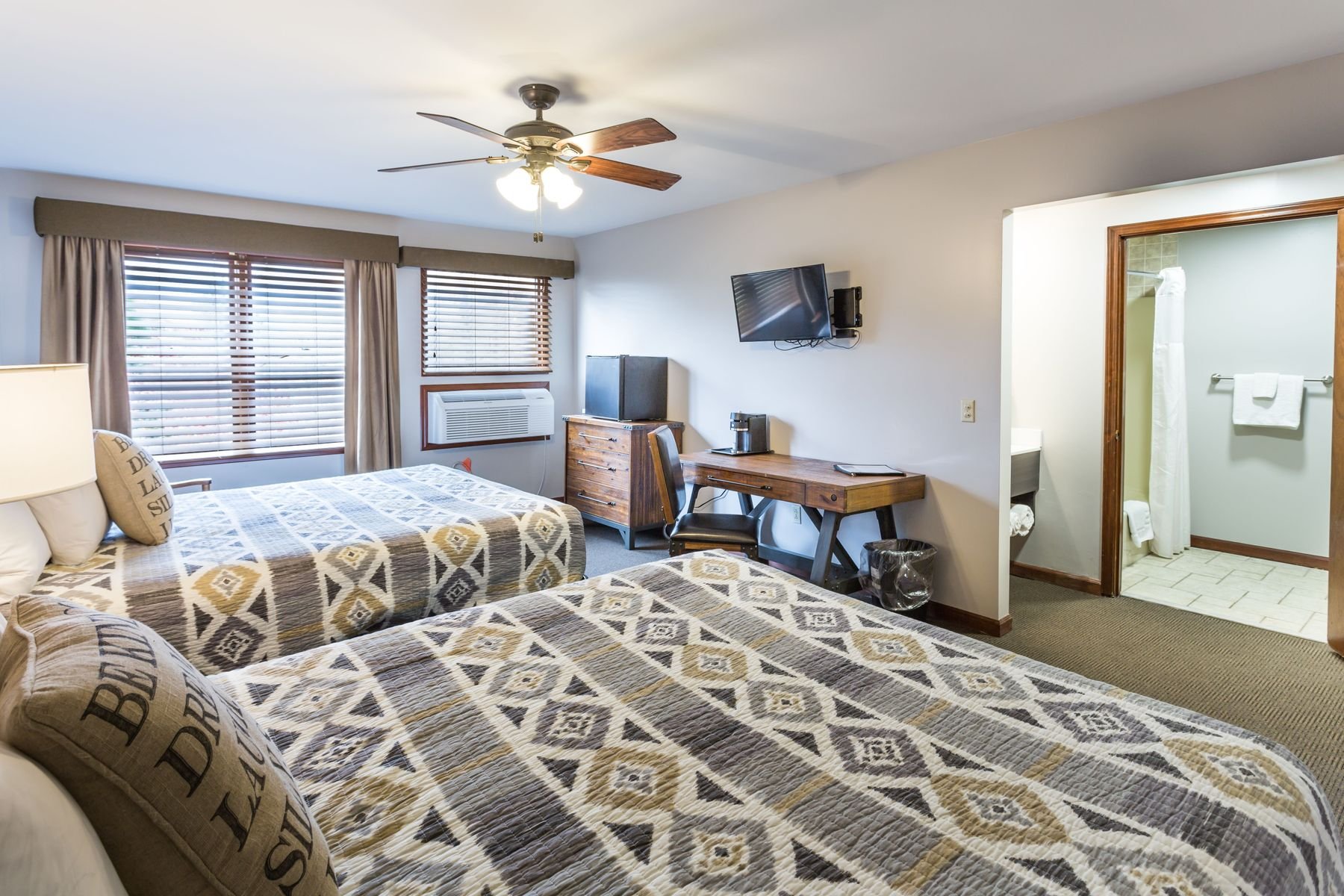In-room mini-fridge and full private bathroom layout inside a standard lodge room.