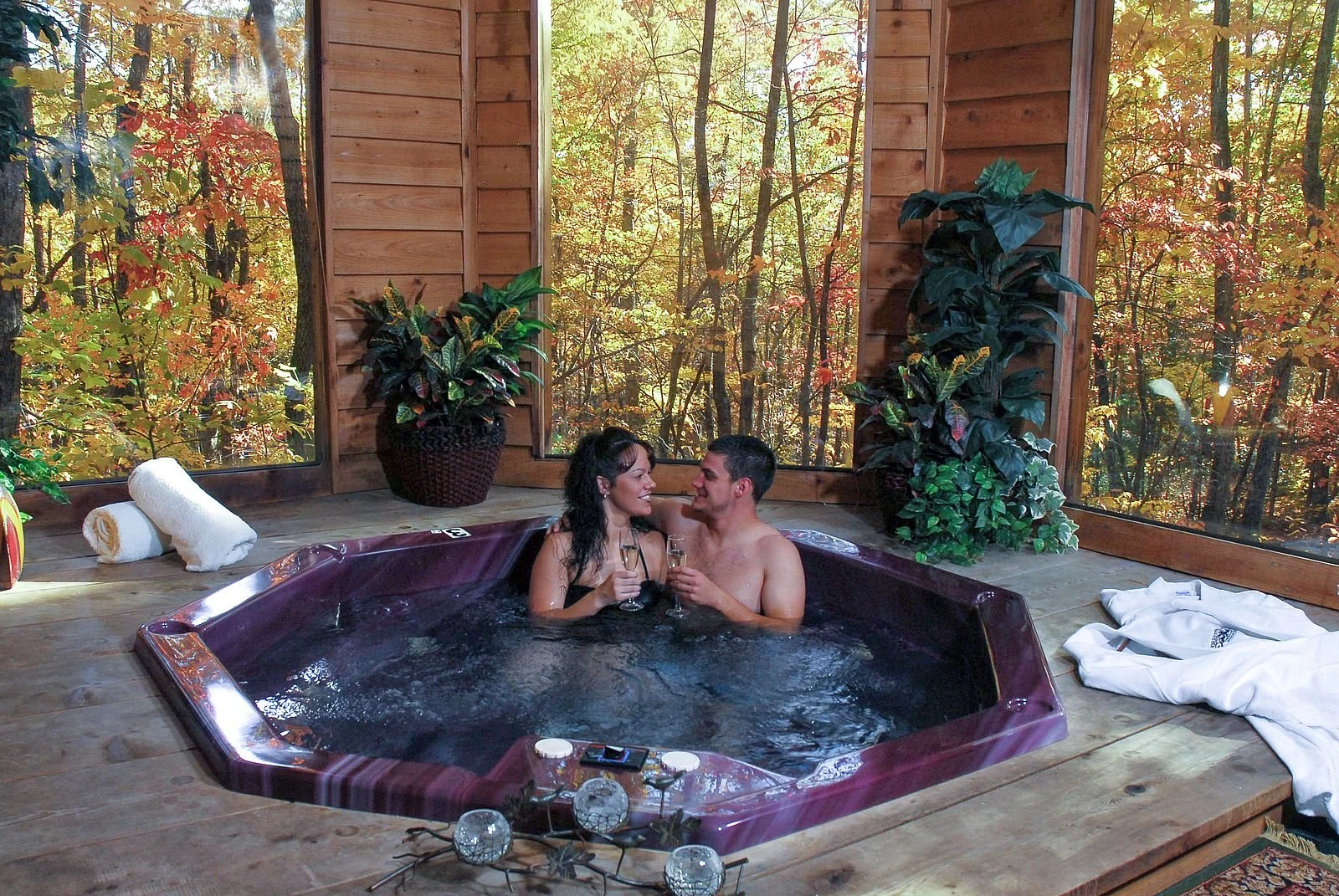 Couple sitting in hot tub enjoying sparkling cider
