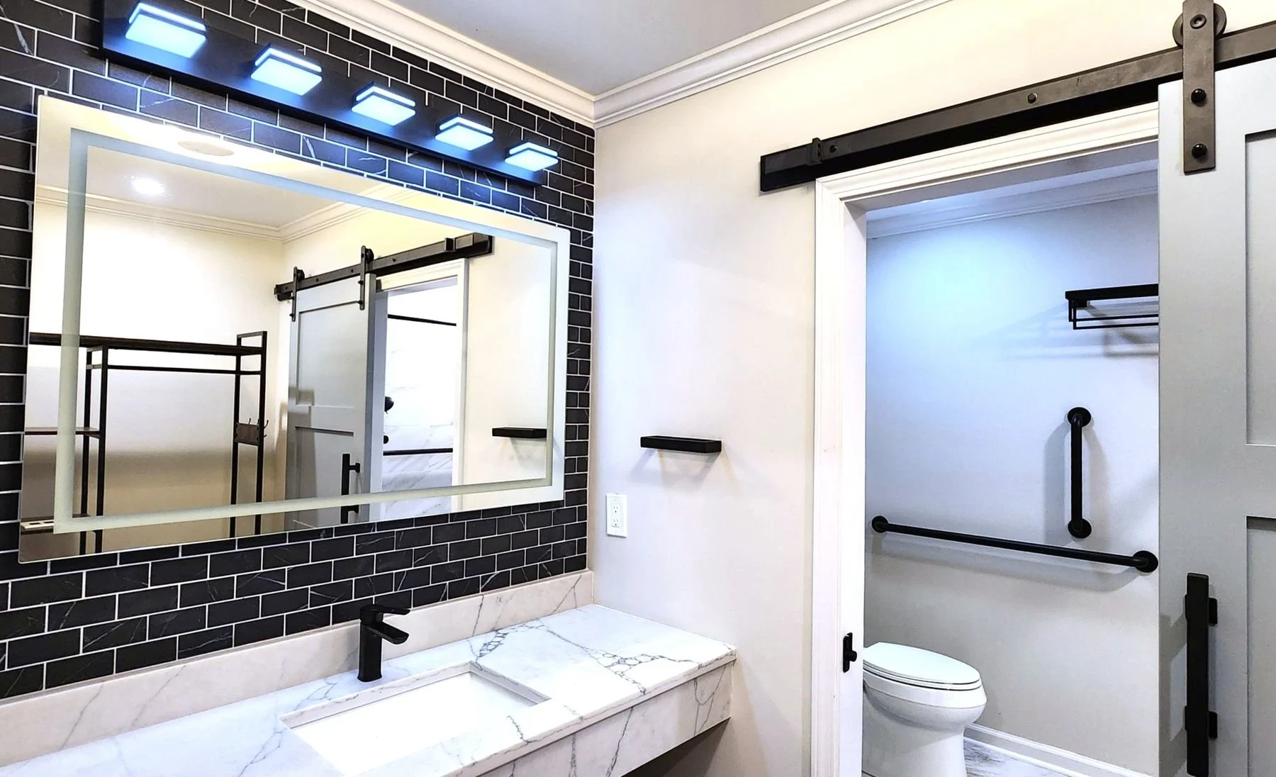 Modern bathroom remodel featuring a large custom walk-in tile shower in the Wilderness Lodge.