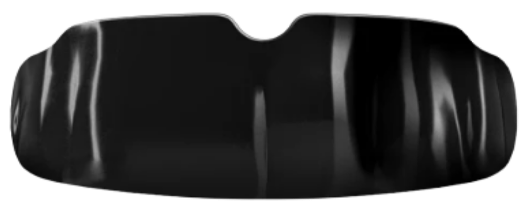Close-up of a black object with a textured surface and curved indentations.
