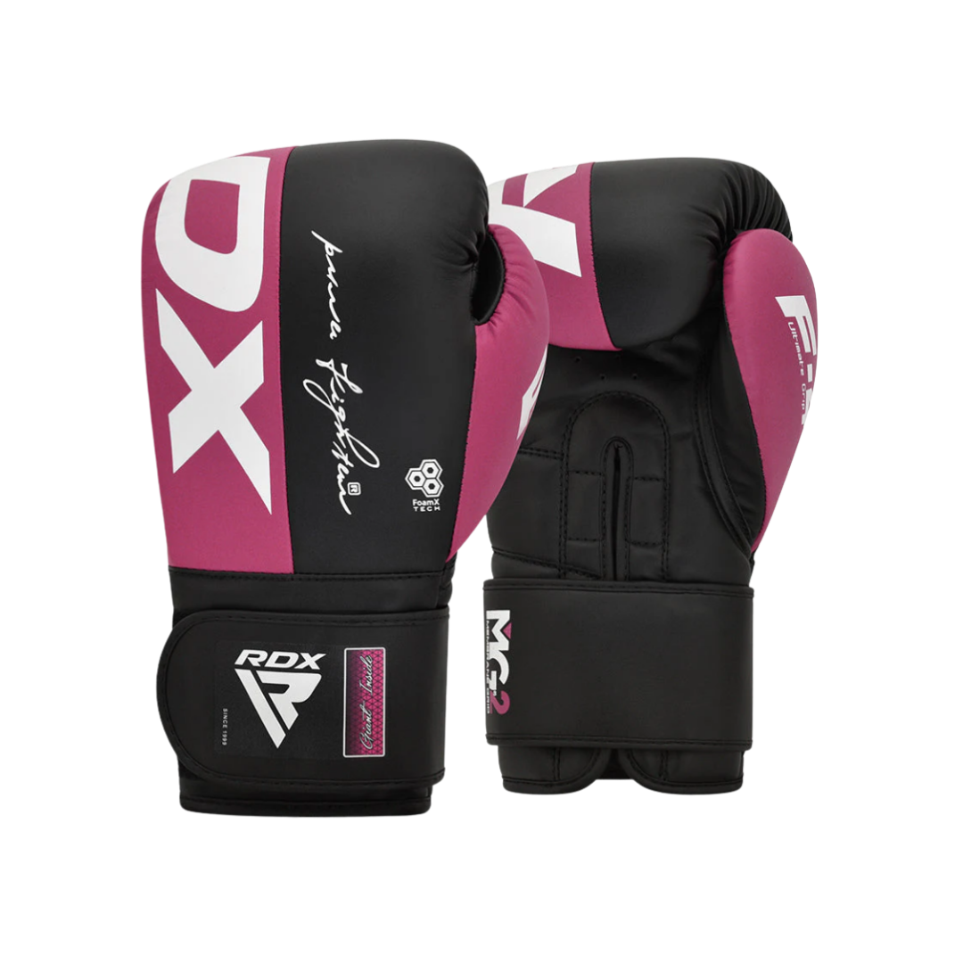 Pair of black and pink boxing gloves with brand logos and signatures.