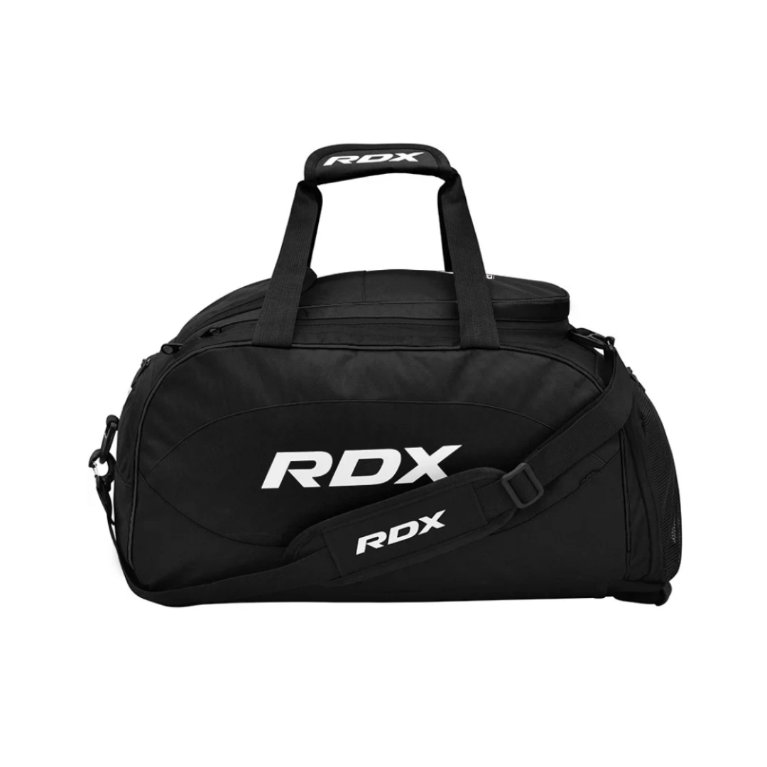 Black sports duffel bag with white RDX logo and handles, shoulder strap, and compartments on a plain background.