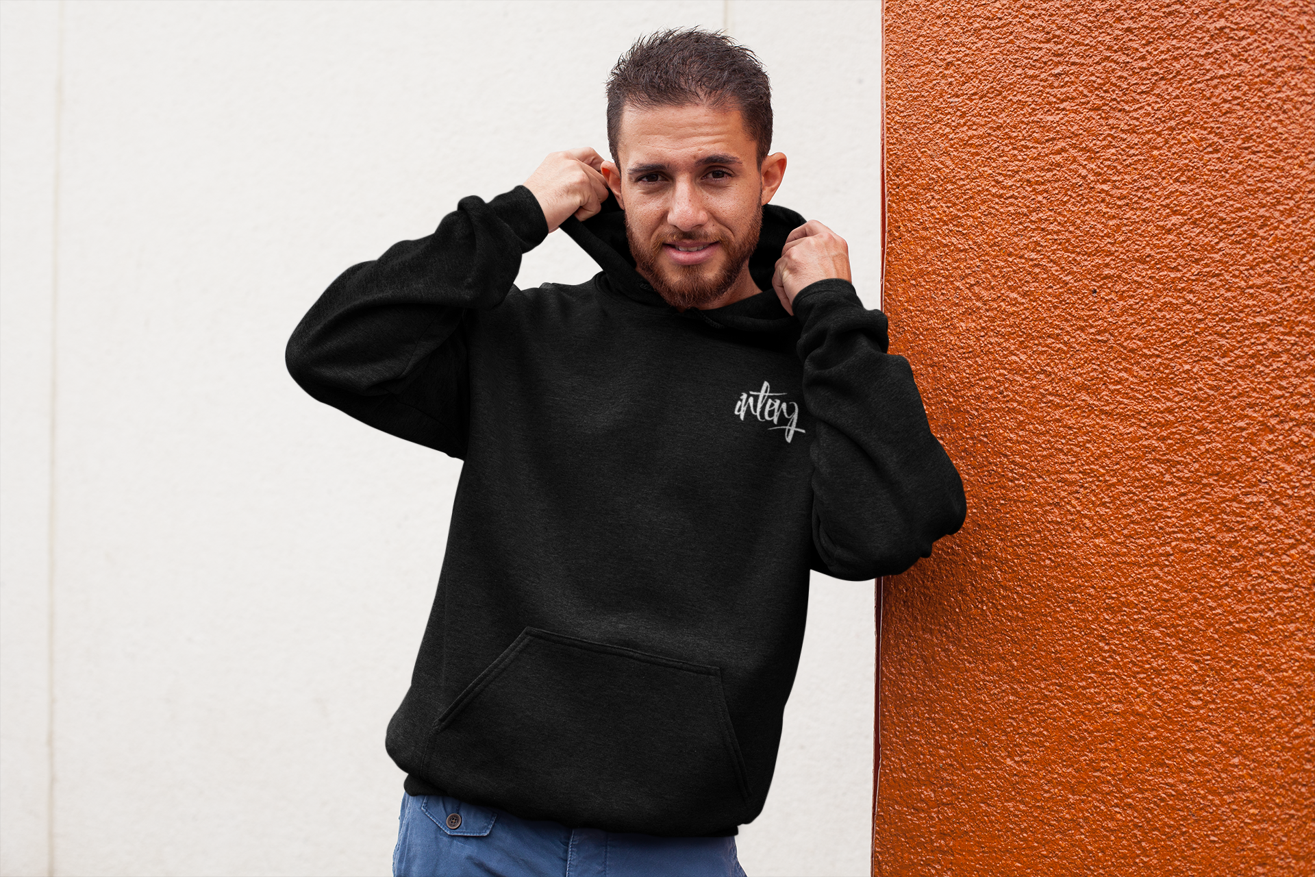 heathered-hoodie-pullover-mockup-of-a-man-leaning-on-a-bicolor-wall-28627.png