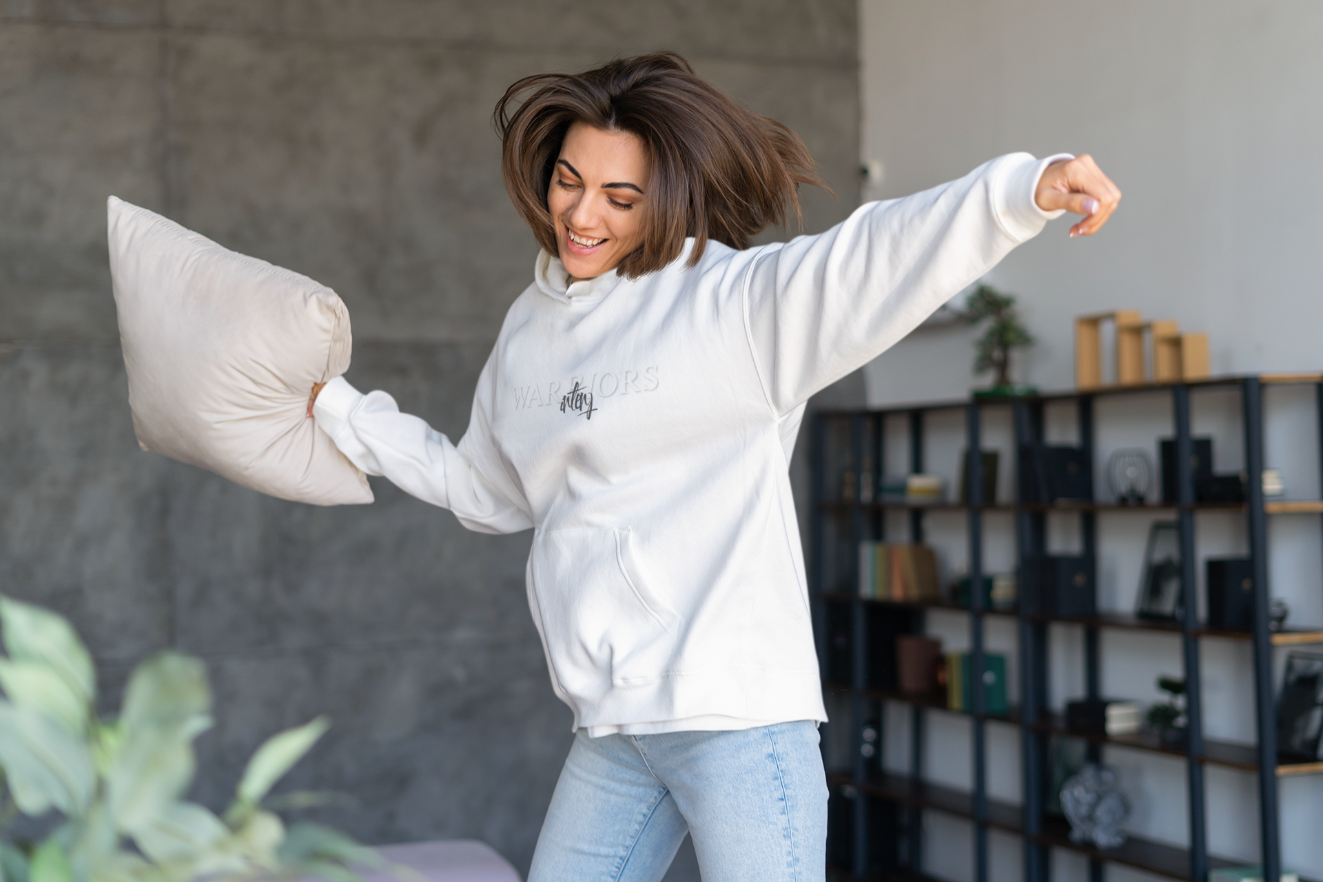 hoodie-mockup-featuring-a-smiling-woman-dancing-at-home-and-holding-a-pillow-m18999-r-el2.png