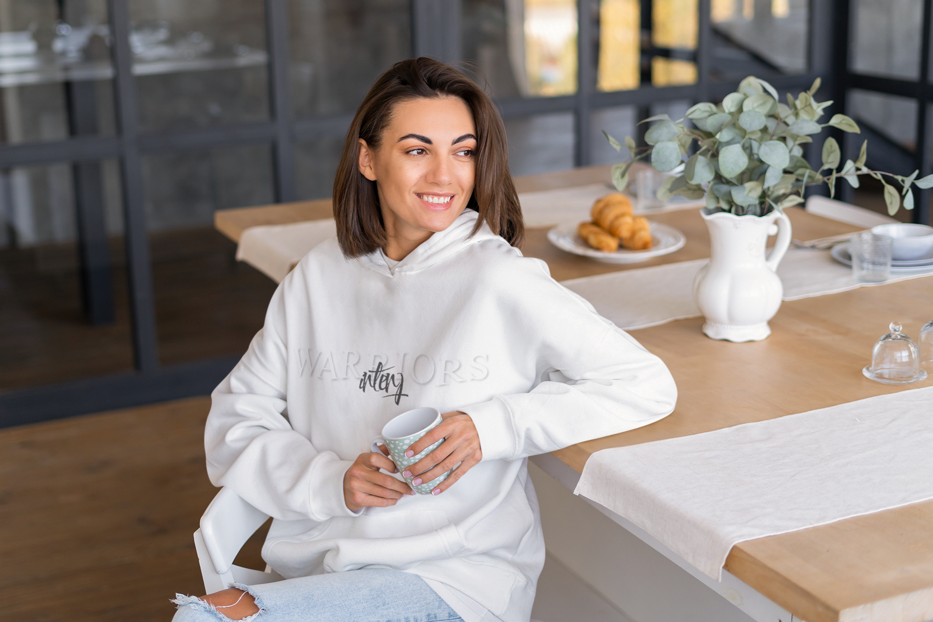 hoodie-mockup-of-a-happy-woman-sitting-on-the-dining-room-table-m18990-r-el2.png