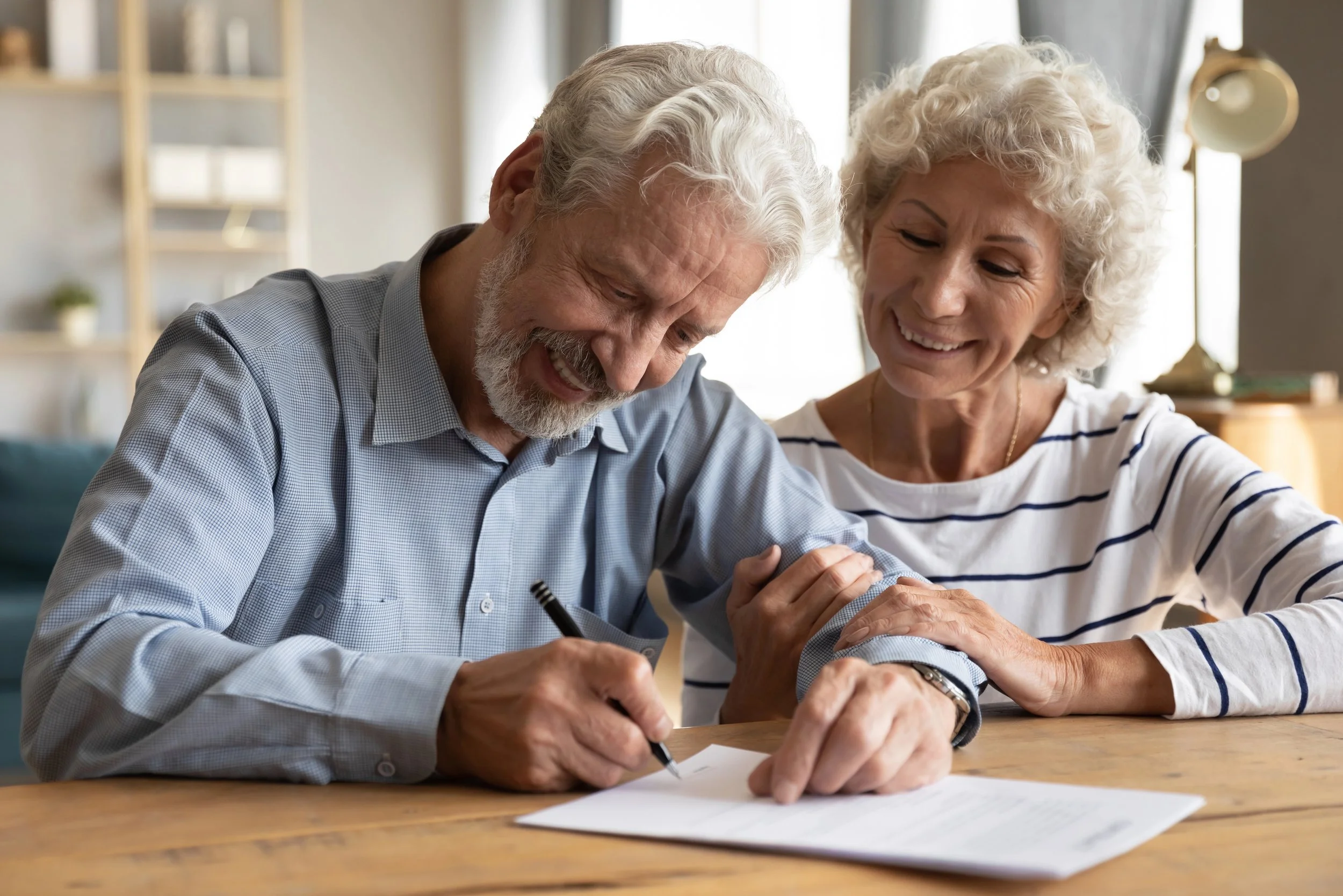 Mobile notary assisting seniors with document signing at home in the West Valley