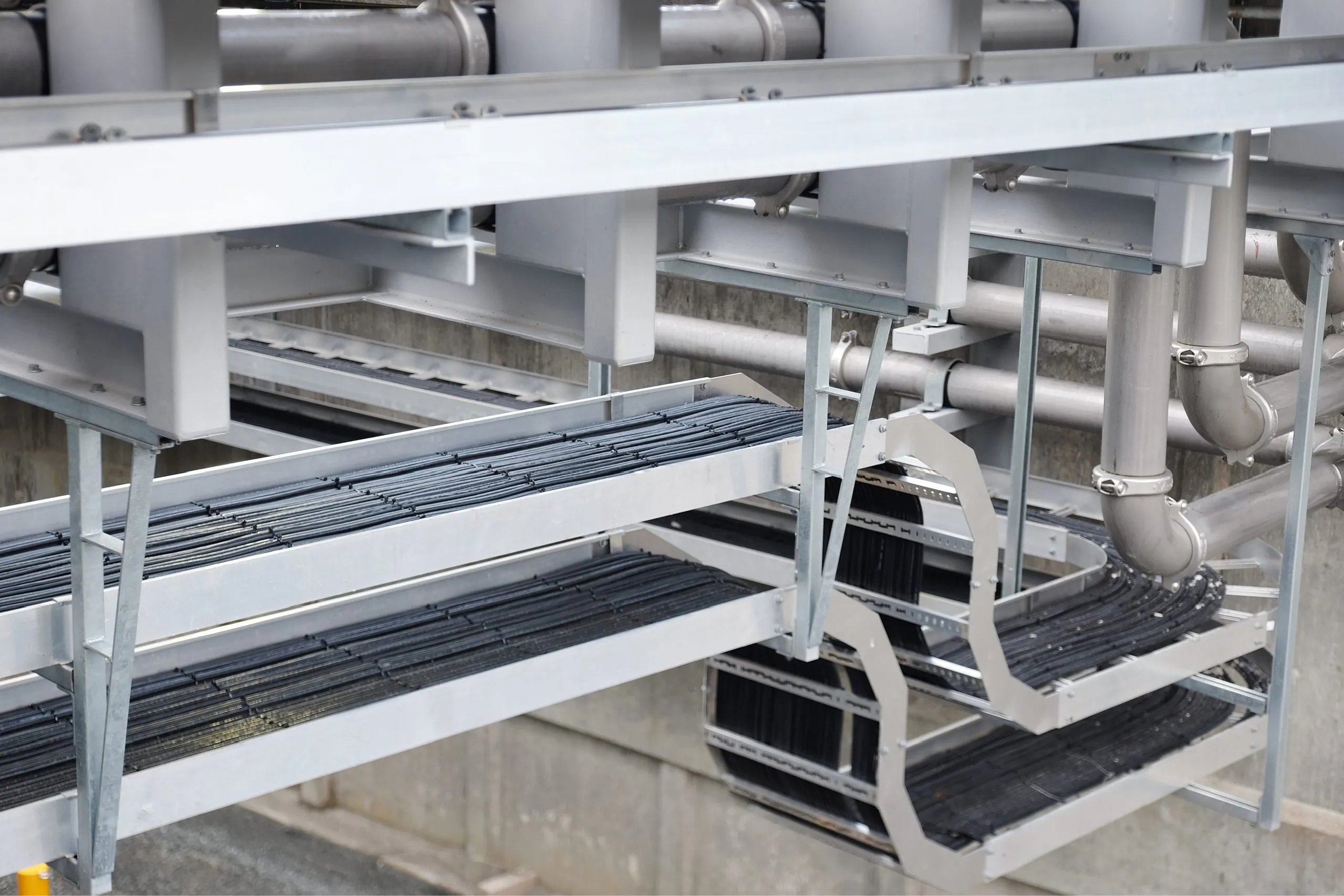 Industrial equipment with various electrical cords and pipes incased within the metal structure surrounded by pipes at Te Mārua Dissolved Air Flotation Plant installed by Stewart Electrical.