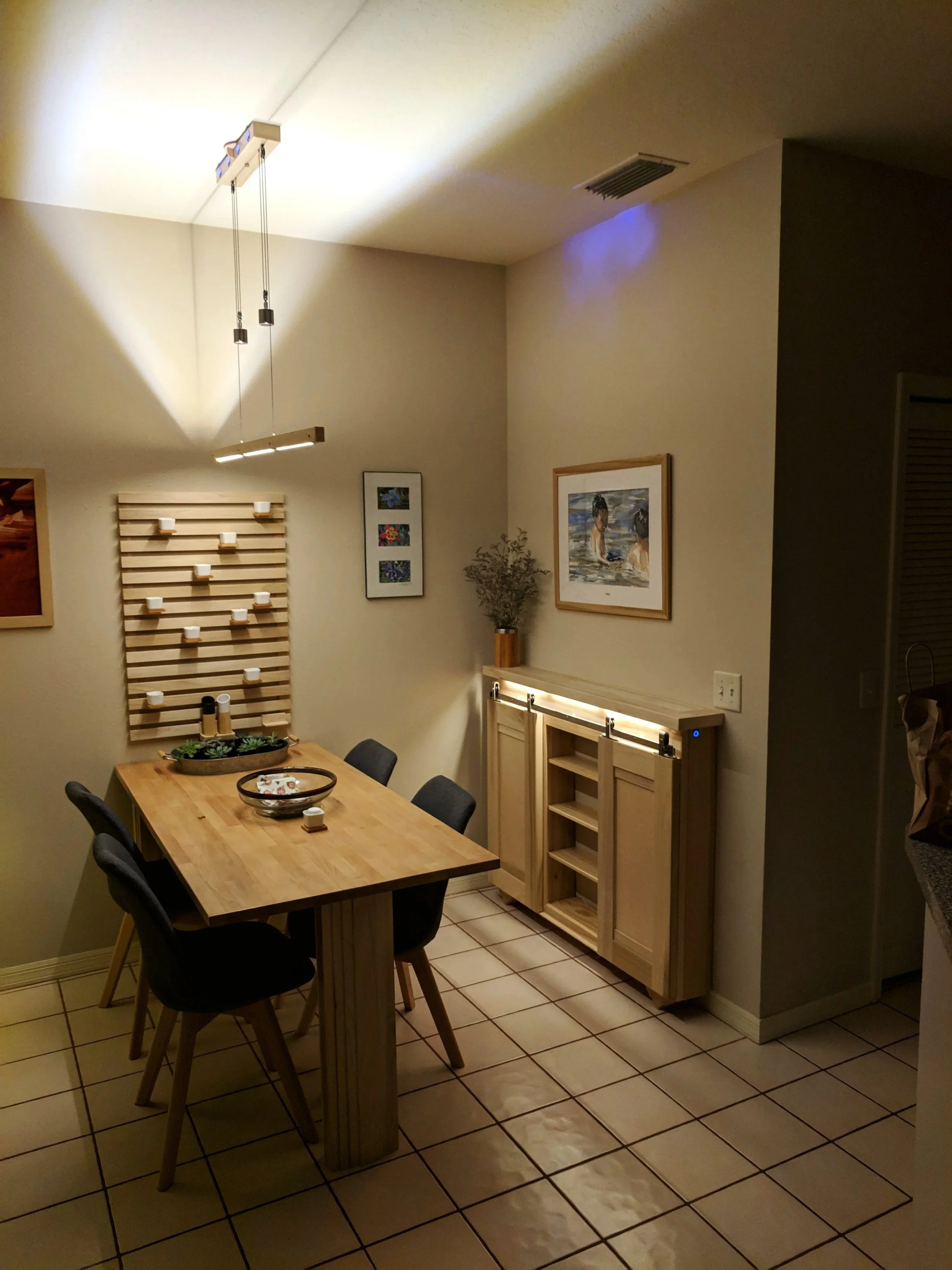 Water color display in custom breakfast nook with barn door sideboard