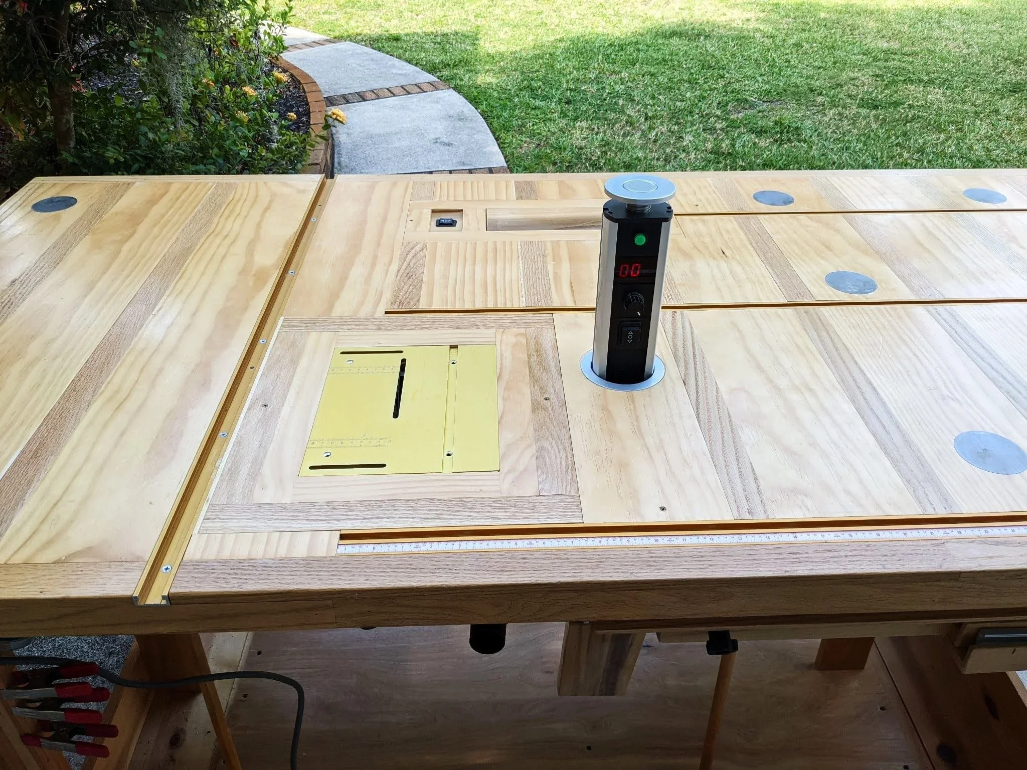 Kayak builders workbench with built in mini table saw and pop up speed controller