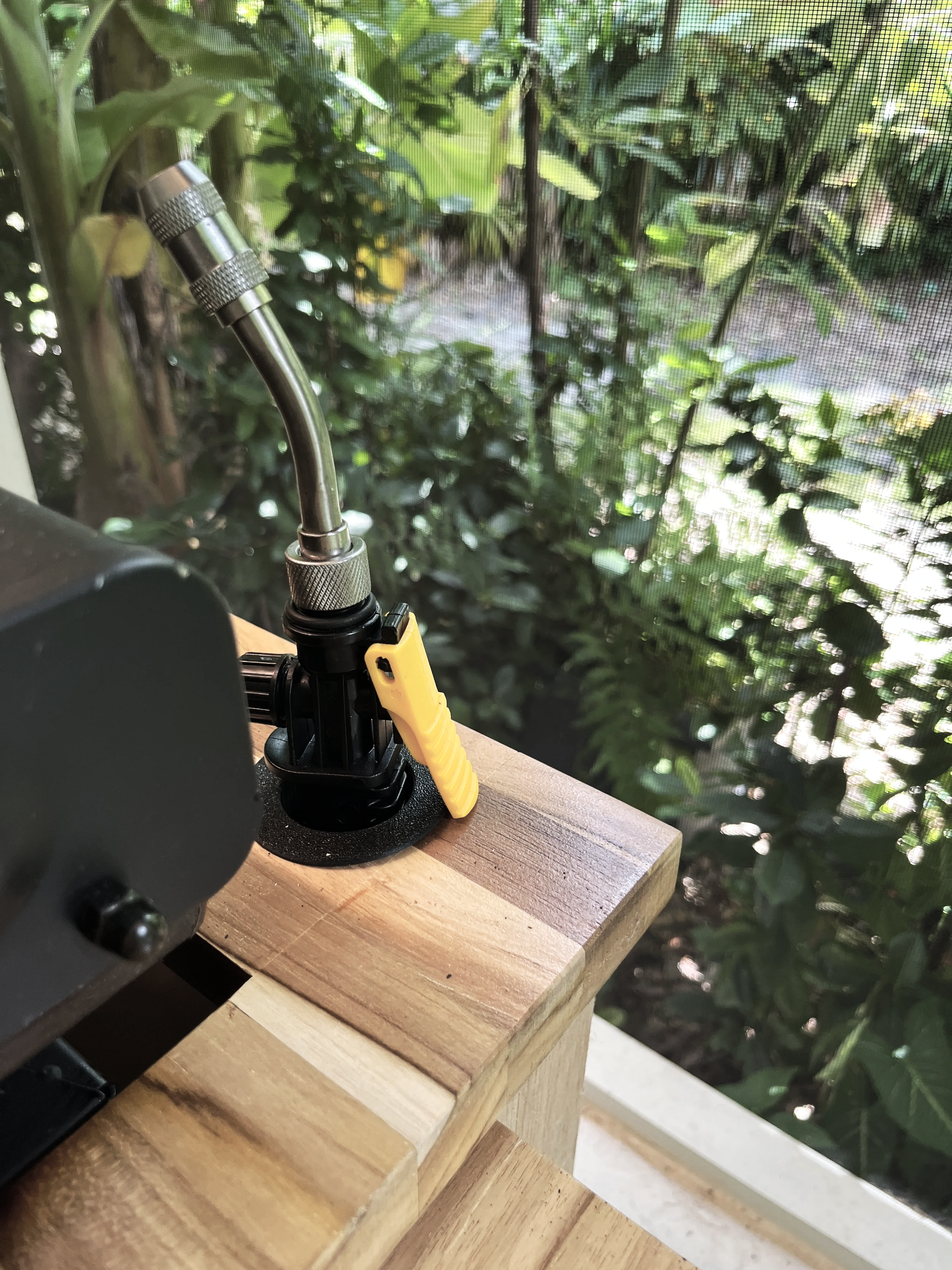 Built-in water sprayer for cleaning a flat-top outdoor griddle