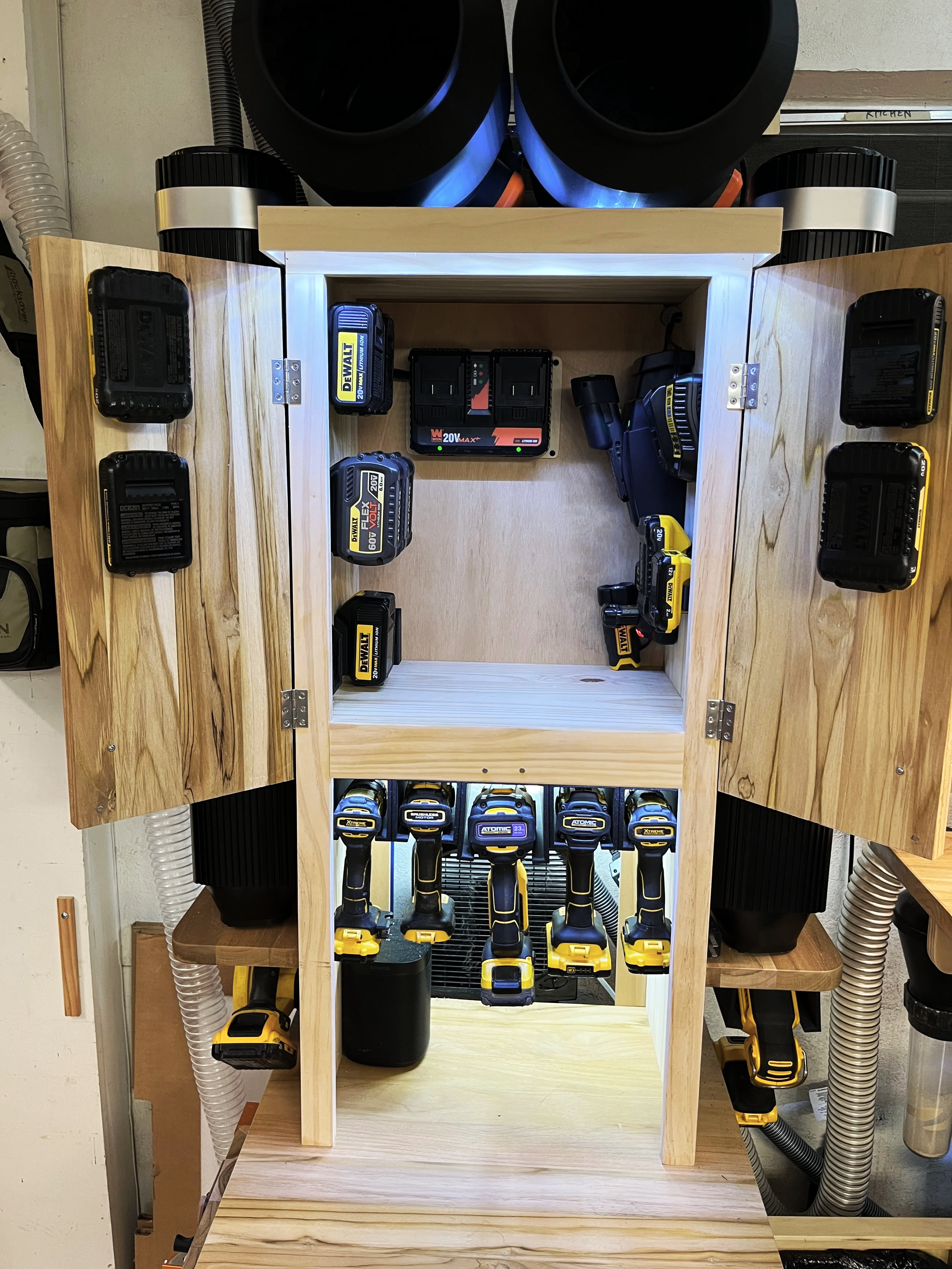Integrated tool charging station and storage in a custom woodworking shop