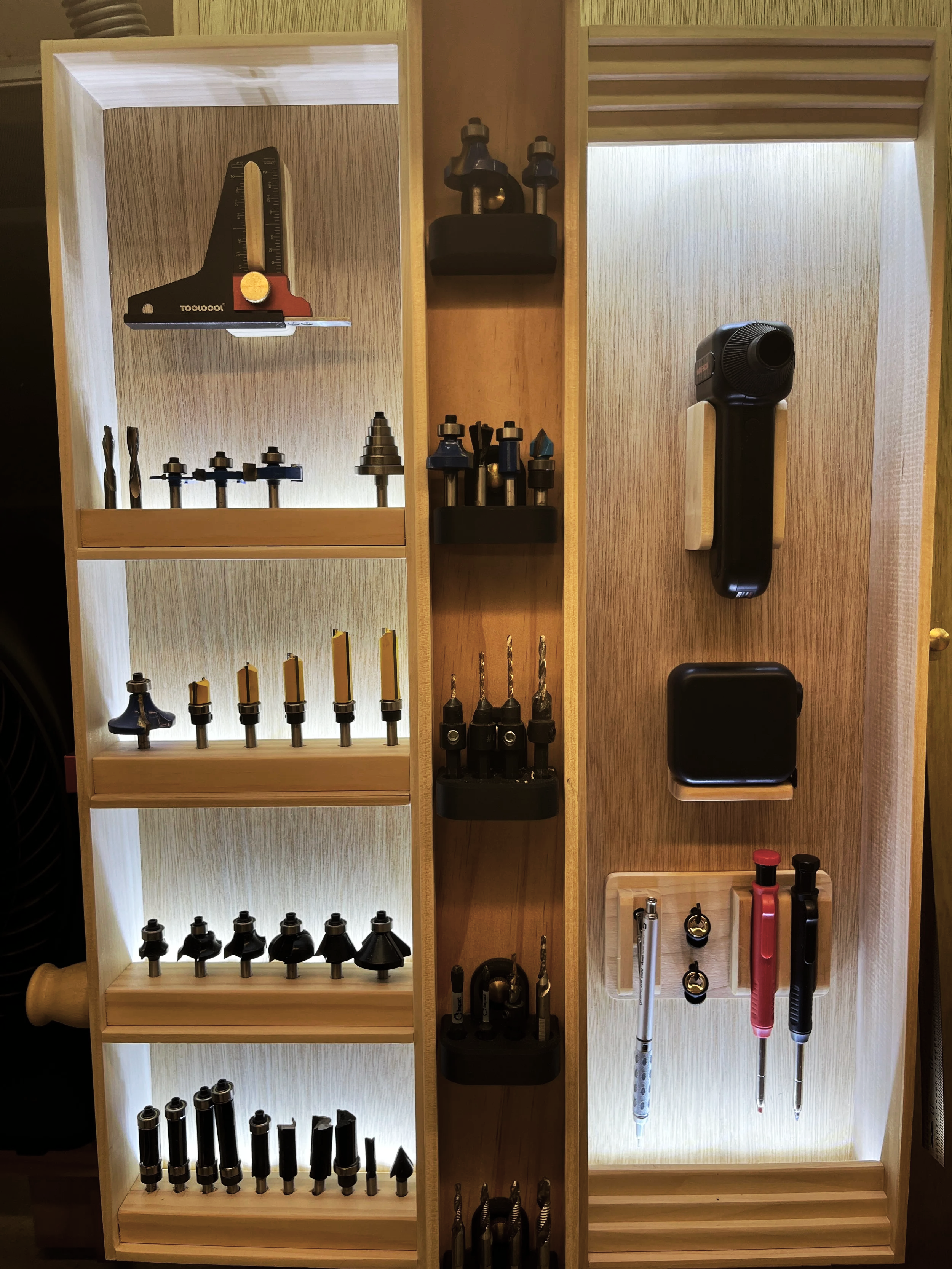 Back lit router bit storage and arms reach tool storage for tools frequently used at this station