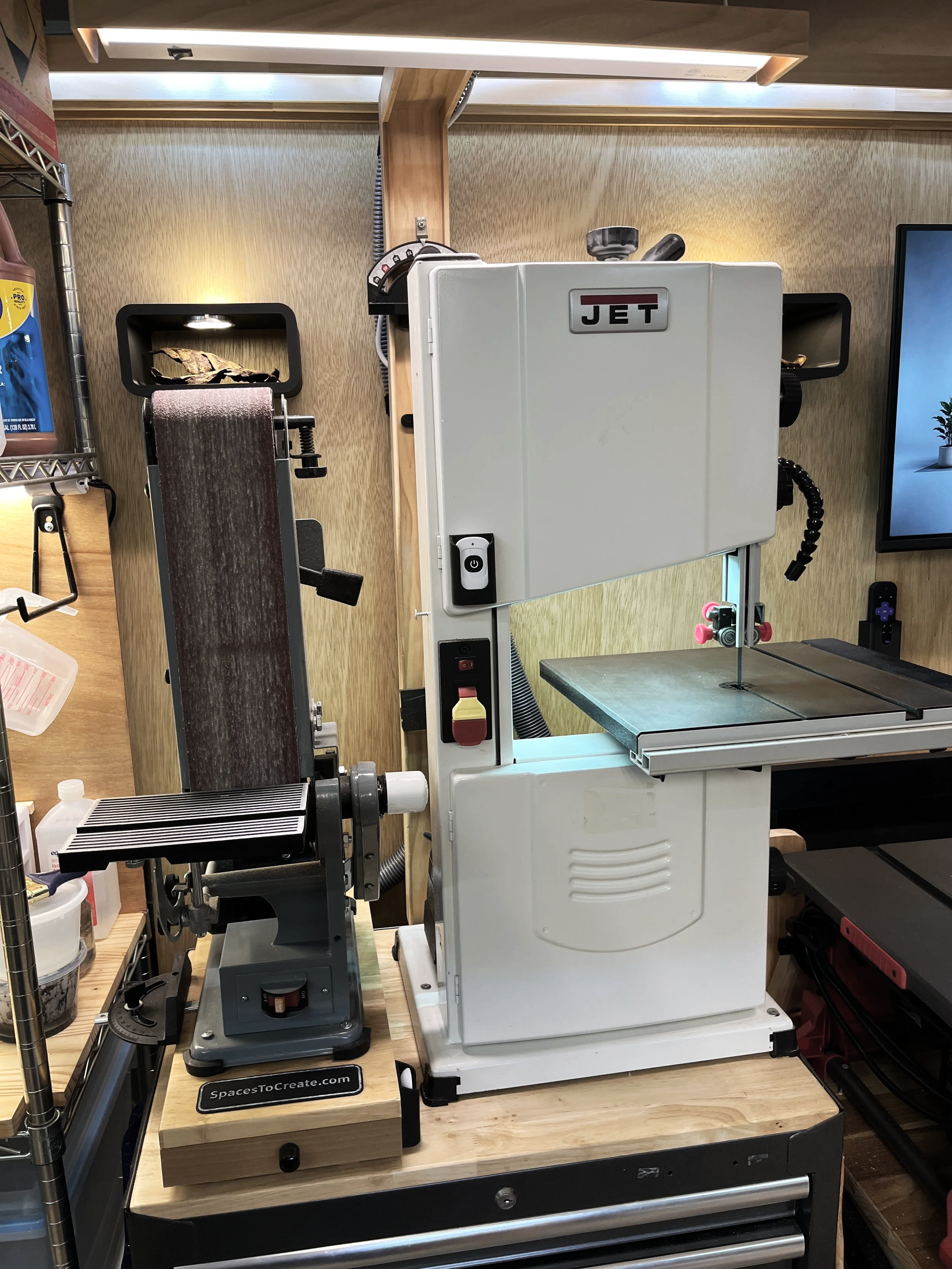 Band saw and sanding station in a custom woodworking shop