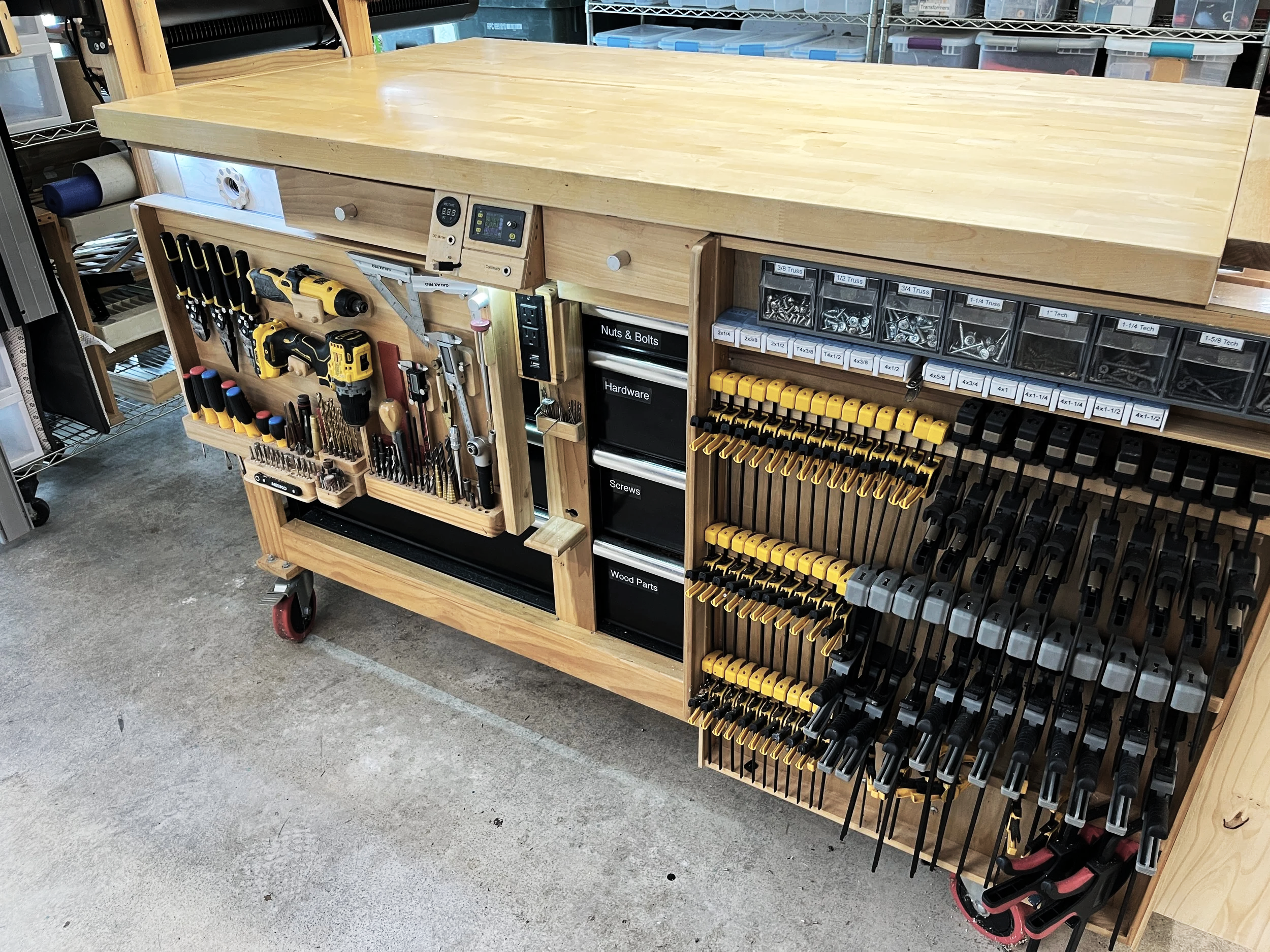 Custom woodworking workbench with pull-out tool storage