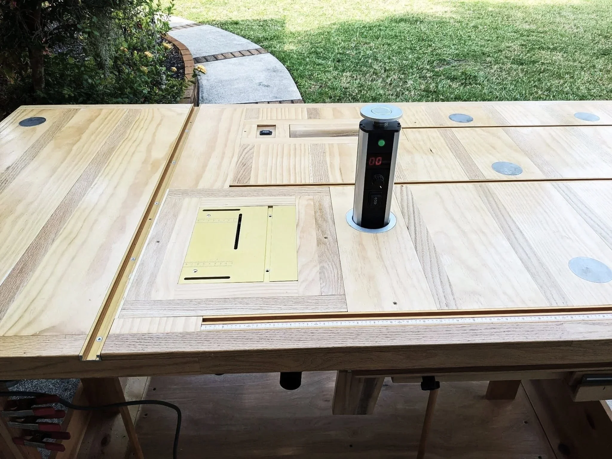 Kayak builders workbench with built in mini table saw and pop up speed controller
