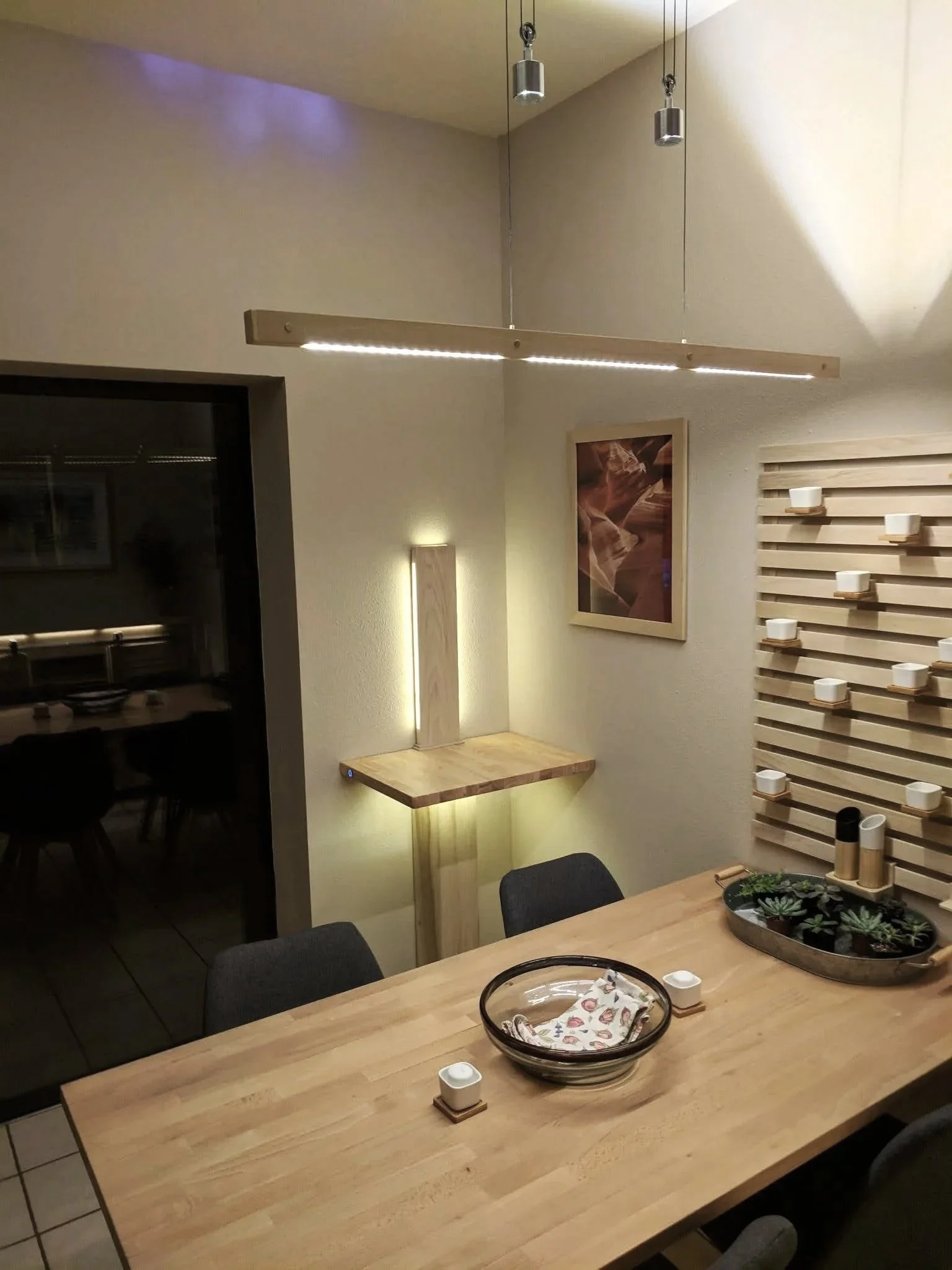 Photography display with custom built side table, lamp and breakfast table