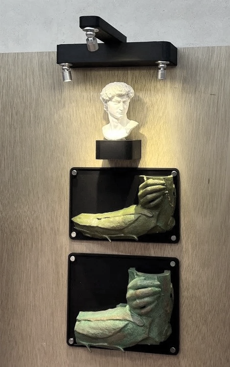 Client artwork samples displayed on custom gallery shelving