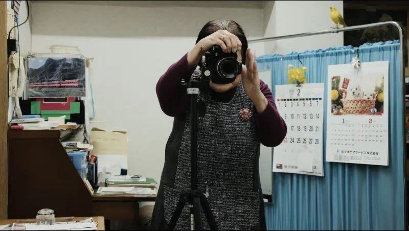 Masao Adachi Takes a Passport Photo