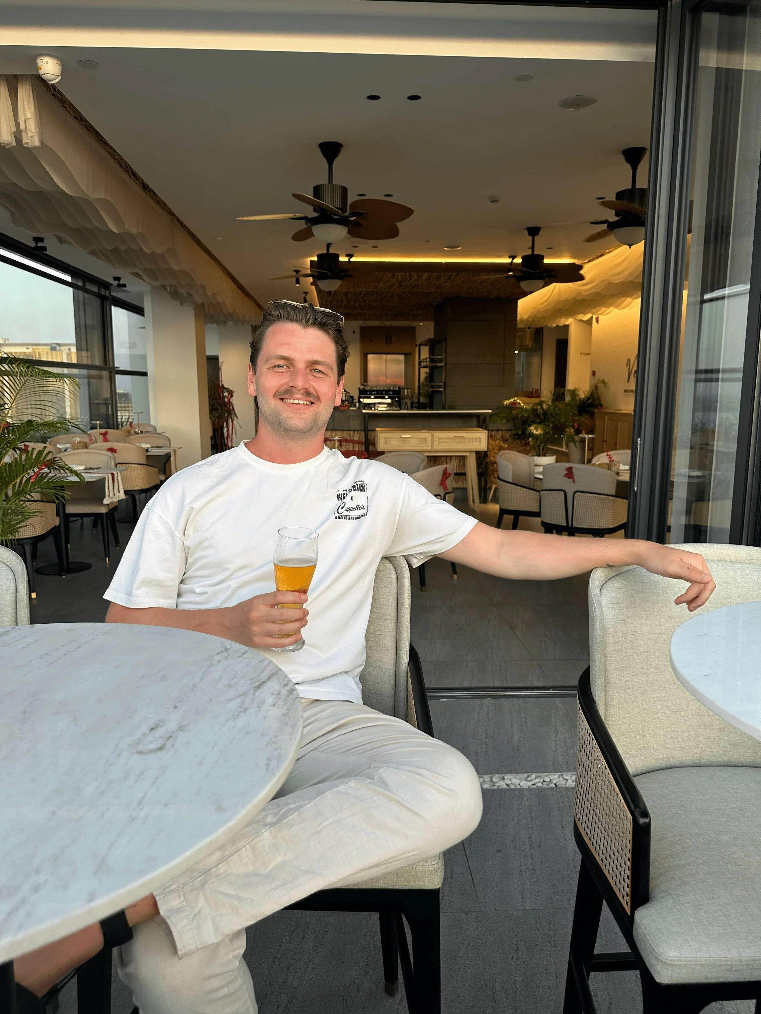 Headshot of Will, co-founder, shot in a bar wearing casual clothing