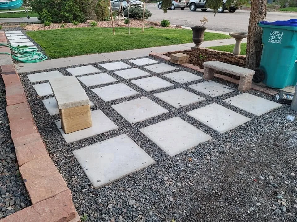 square concrete pavers surrounded by crushed rock