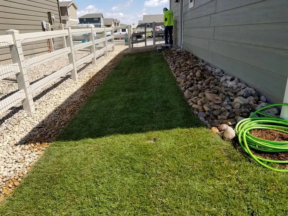 side yard landscaping project featuring rock accents