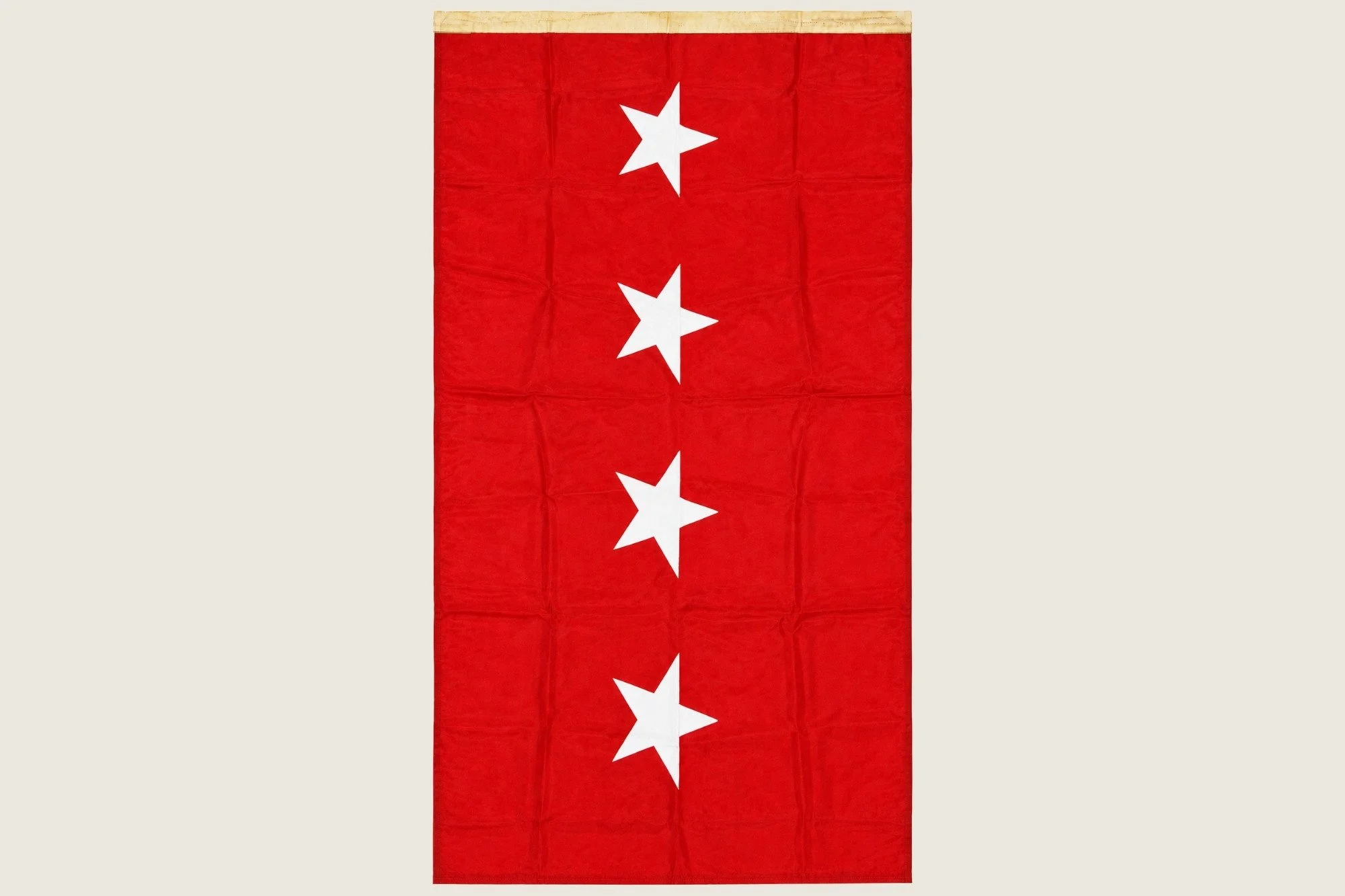 Vertical view of the red headquarters flag showing four white stars.