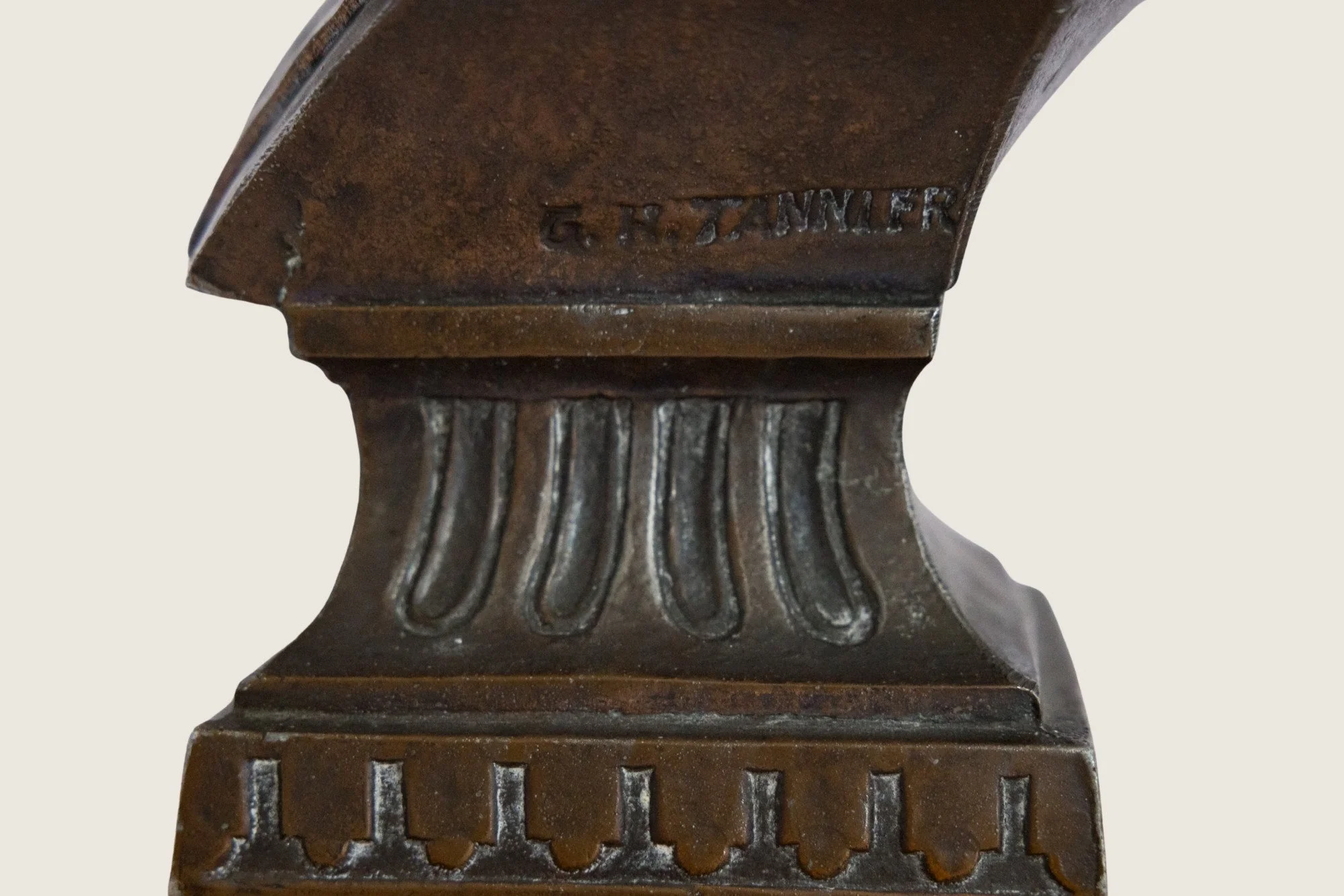Close detail of an impressed maker’s mark on the William McKinley commemorative bust.