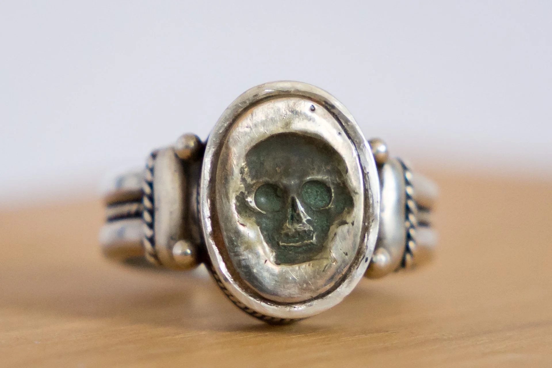 Front view of a Georgian silver memento mori ring with a skull motif in the bezel.