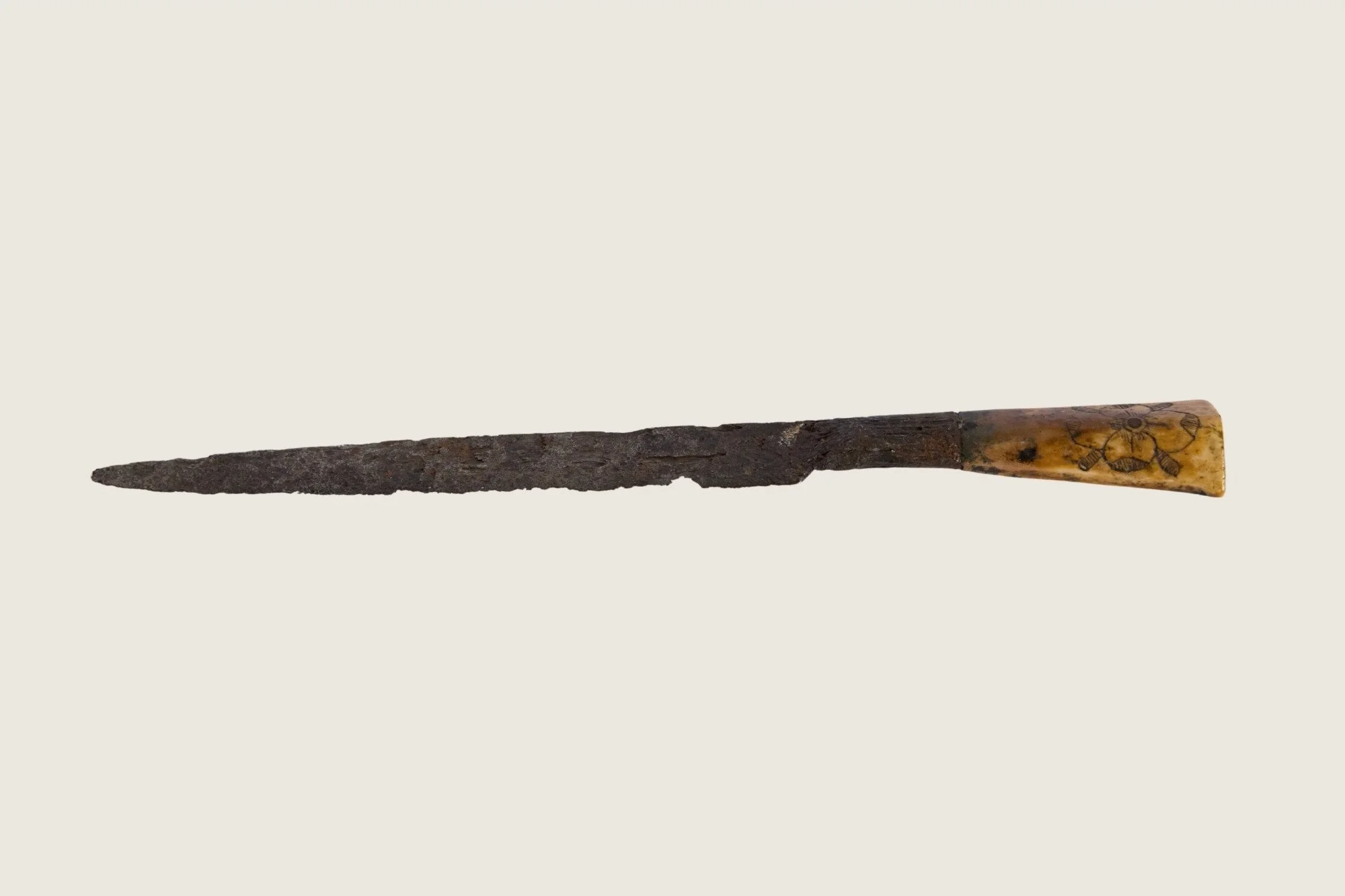 Opposite-side view of the Stuart-period iron knife with corroded blade and decorated handle.
