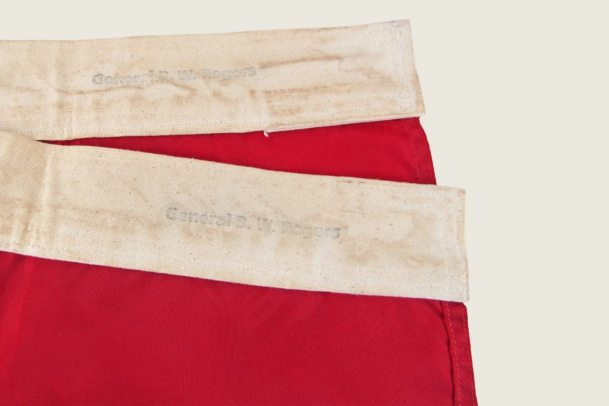 Detail of the hoist edge and stitched construction of the four-star headquarters flag, hand-stamped “General B.W. Rogers.”