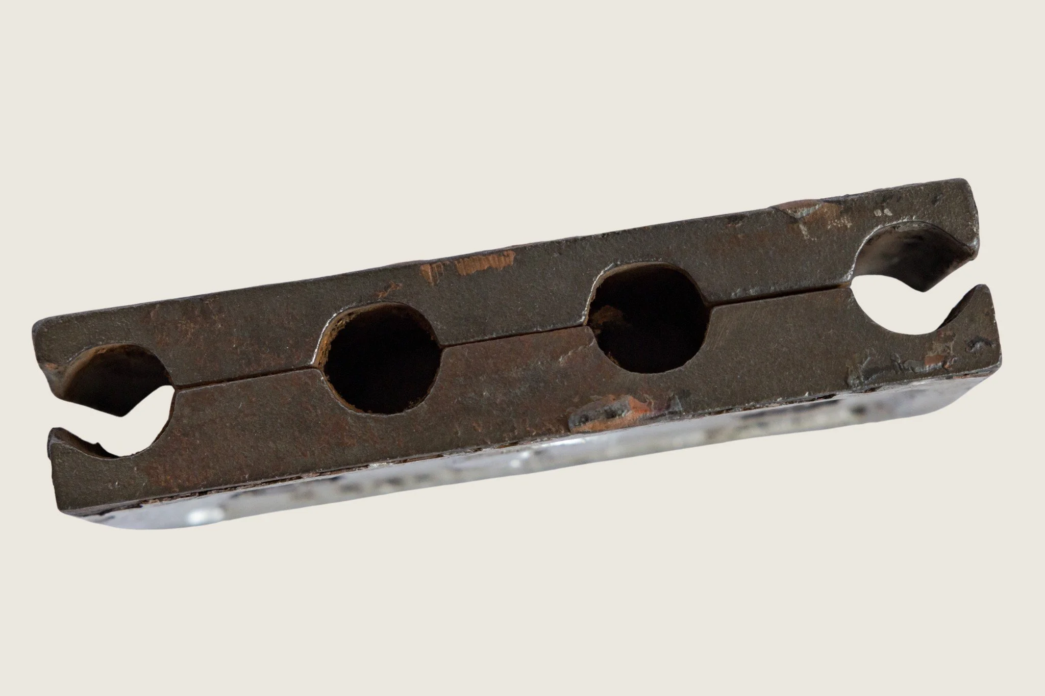 Underside detail of the No. 9 identification clamp showing two circular mounting holes.