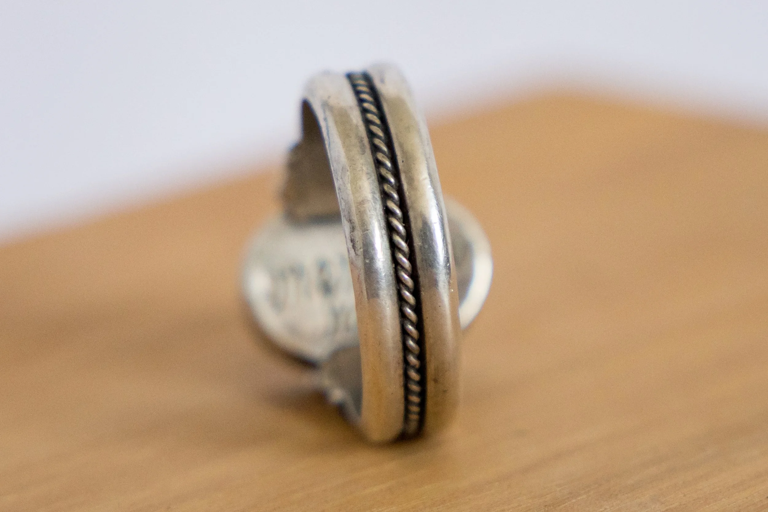 Rear view of the Georgian silver memento mori ring showing the back of the bezel and band.