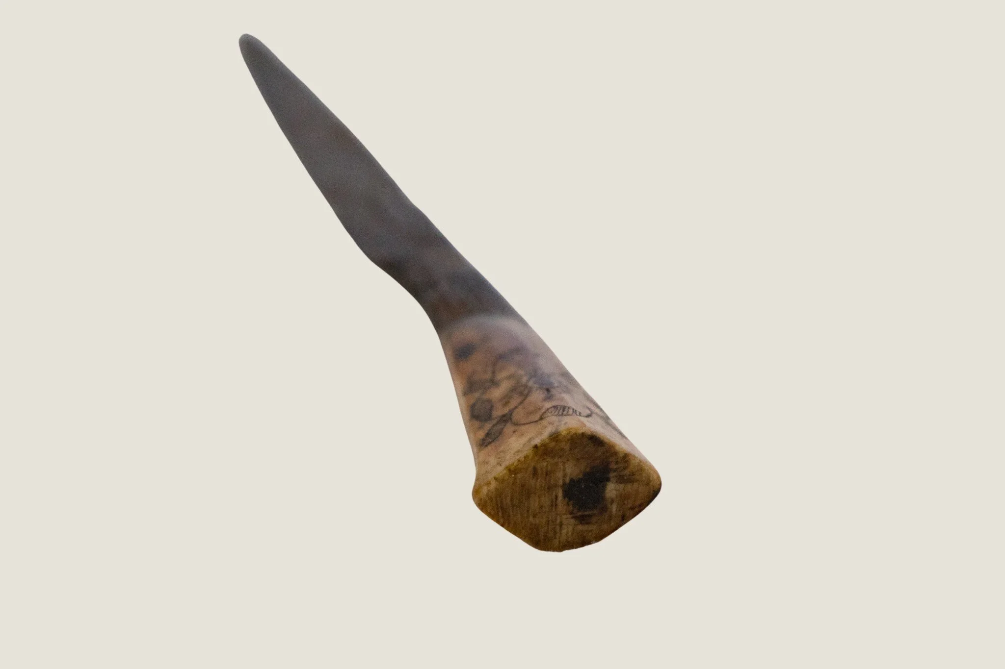 Stuart-period iron knife shown in full, with a corroded blade and decorated pale handle.