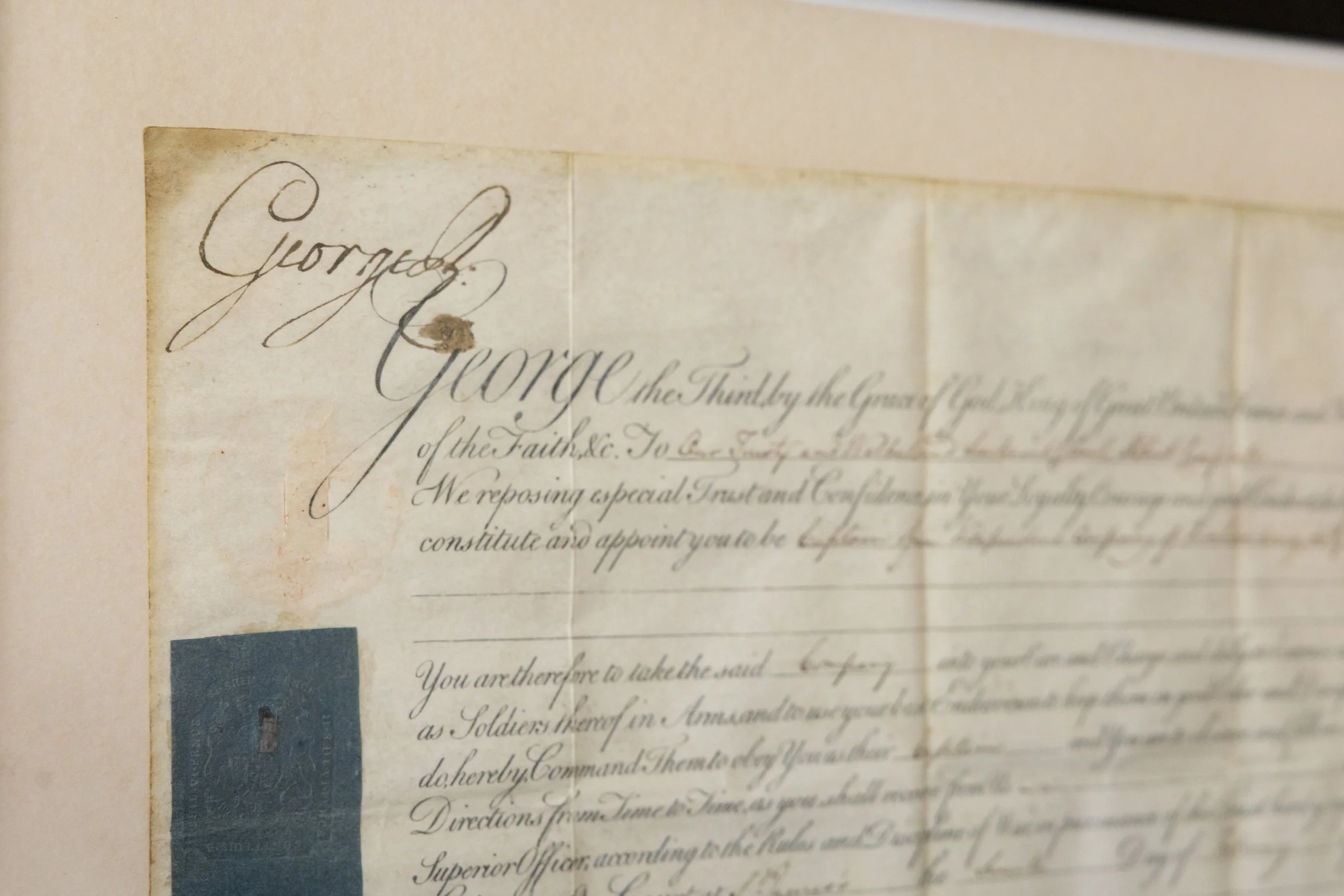 Detail of the Royal manual (signature), royal heading, and blue embossed seal on the 1799 Royal Military Commission.
