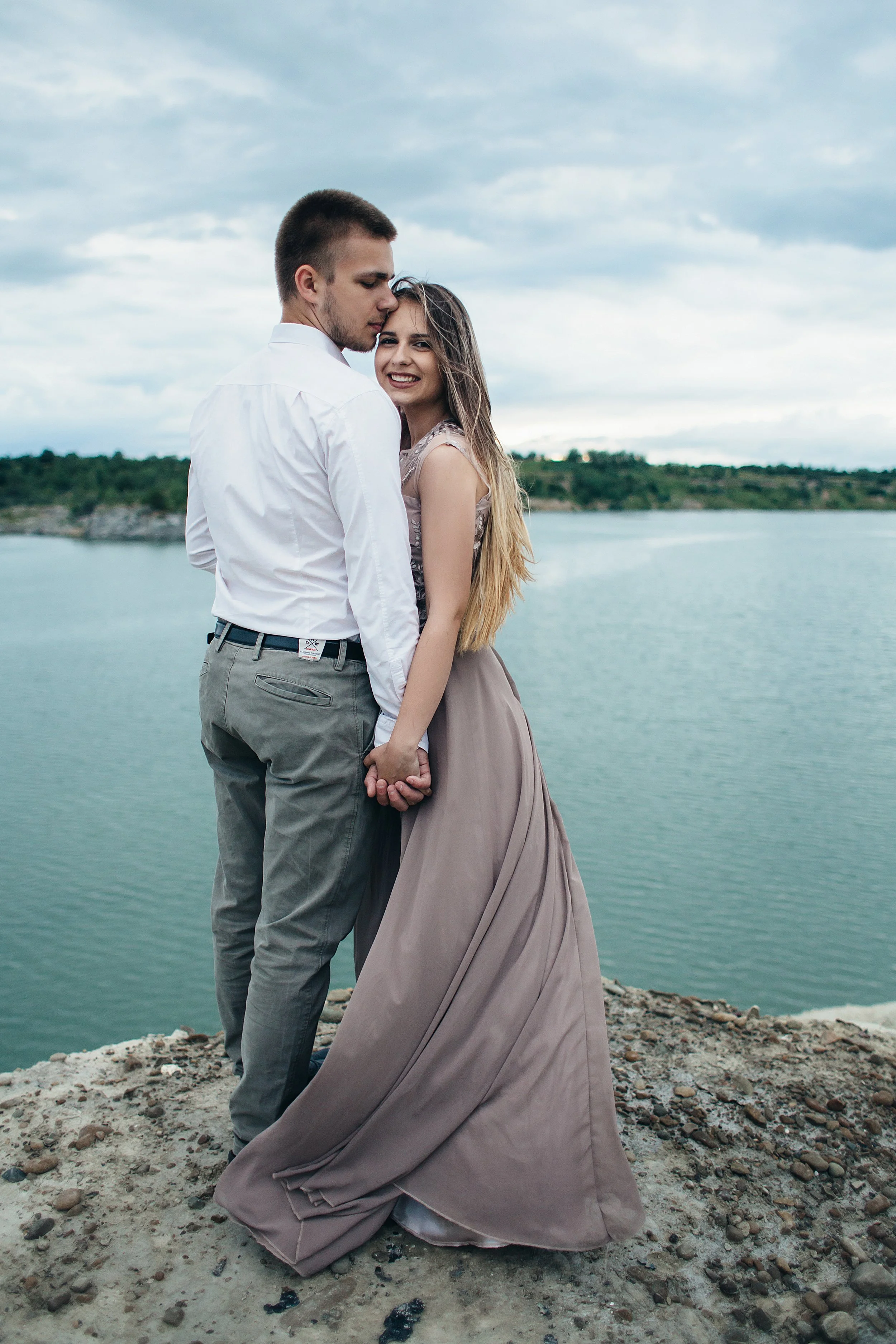 Young couple embracing by a river
