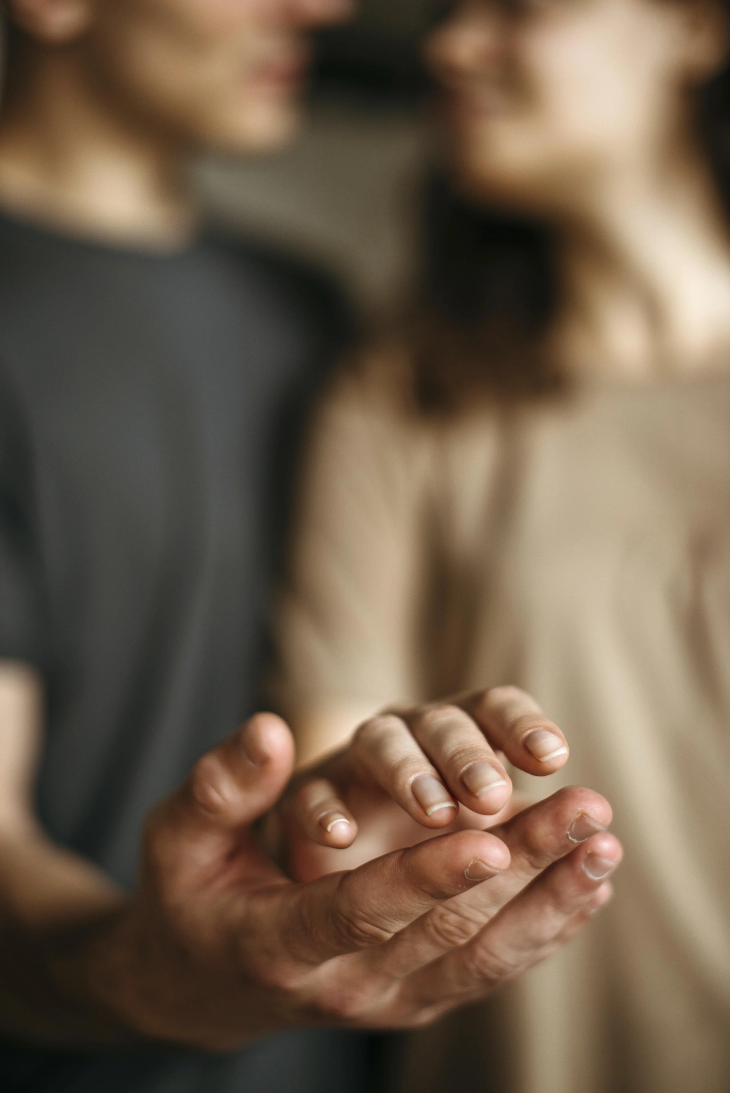 Close up of  the hands of a man and a woman. Their hands are about to clasp.