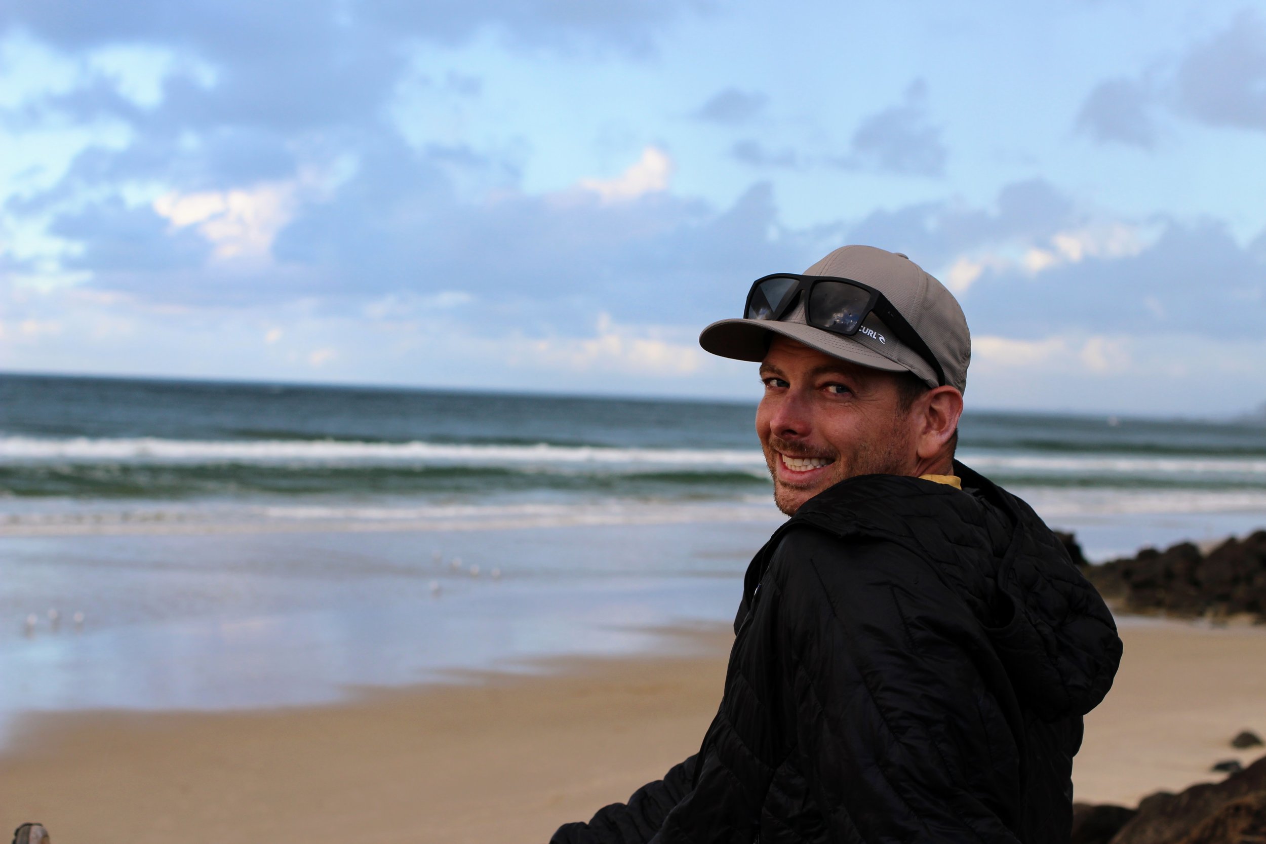 Engineer sitting at a Maui Beach thinking about Cesspool Conversions